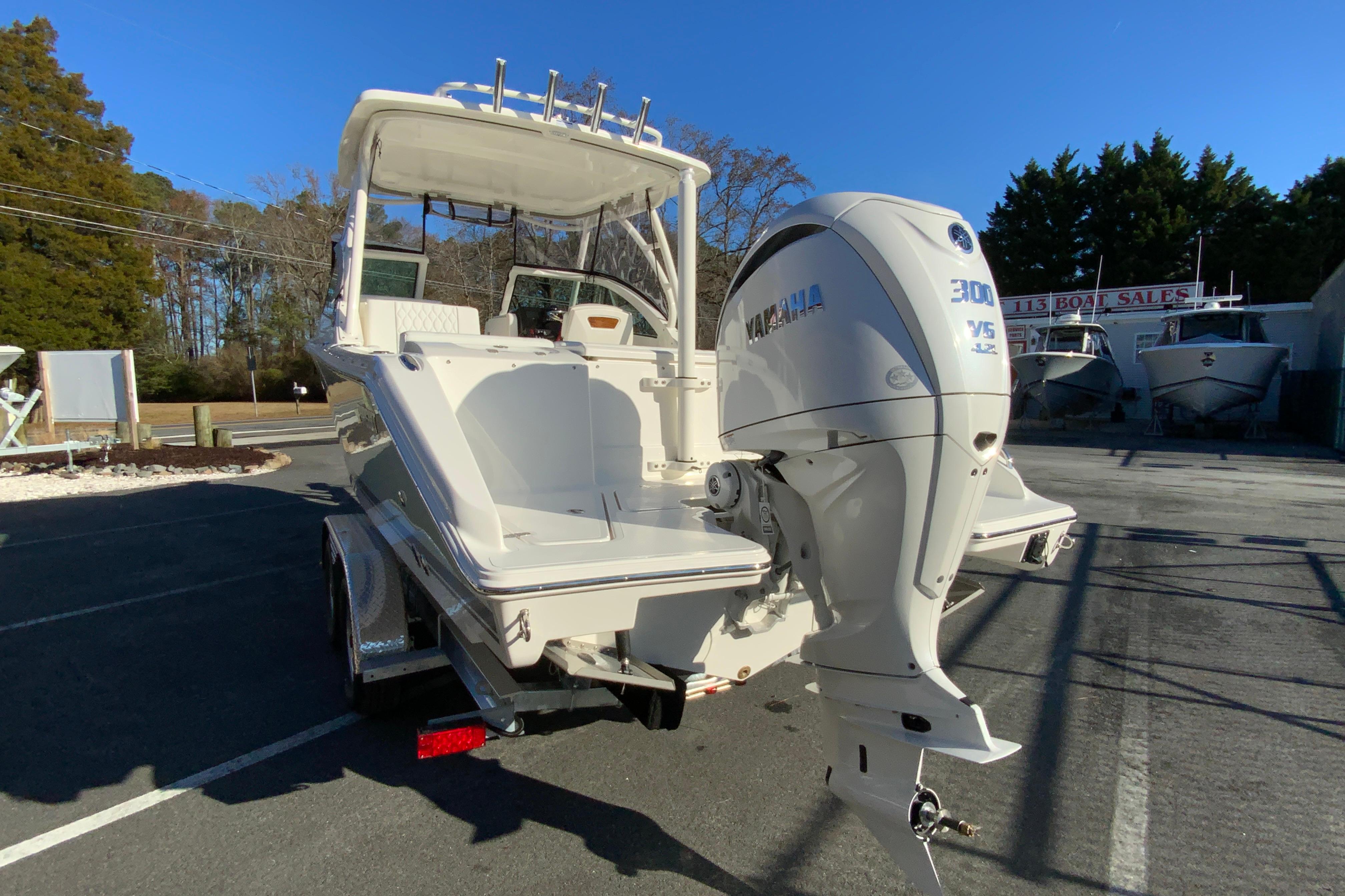 2026 Pursuit DC 246 Dual Console boat with Yamaha 300 engine, parked outdoors.