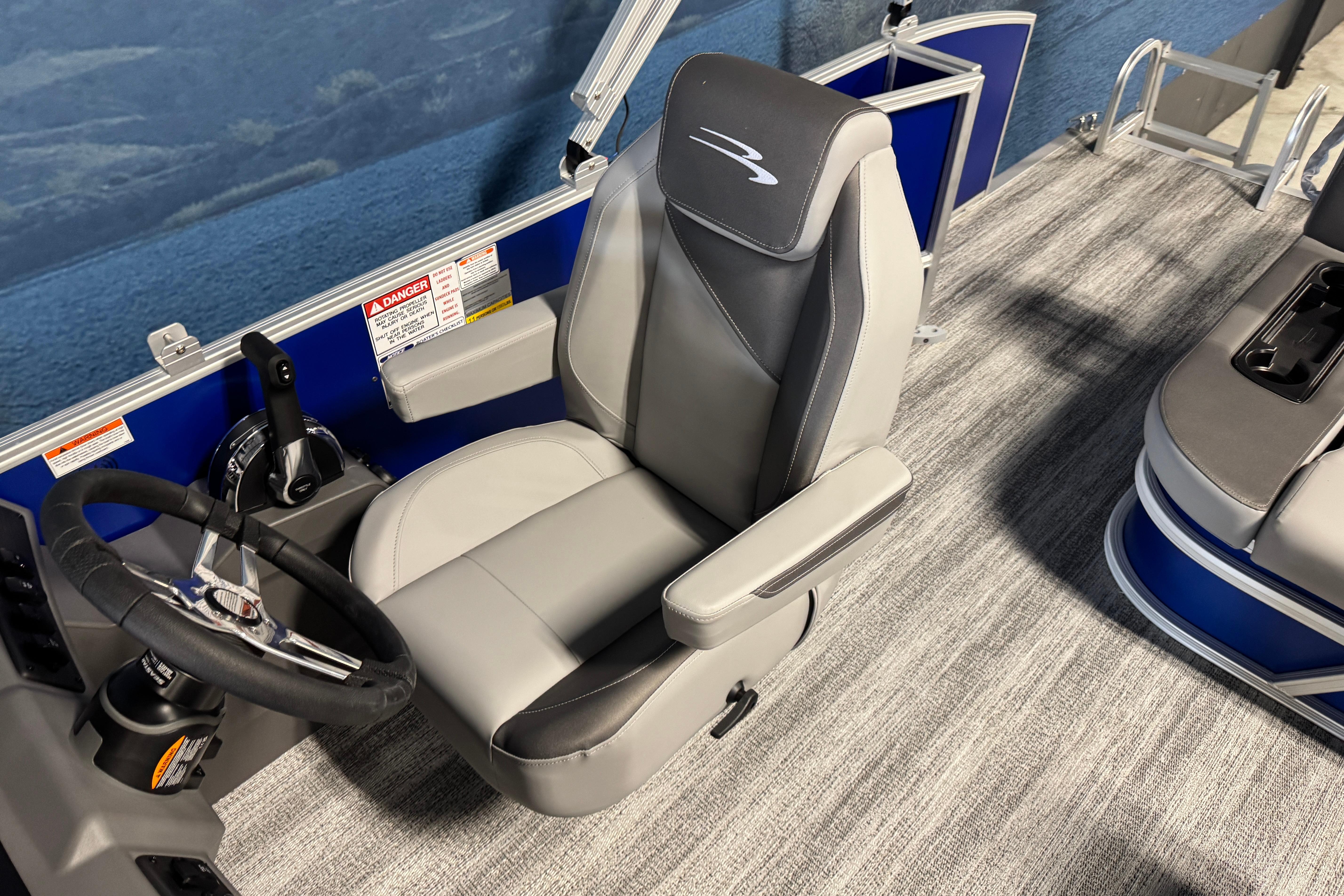 Captain's seat of 2026 Bennington 21 SSB pontoon boat with steering wheel and controls.