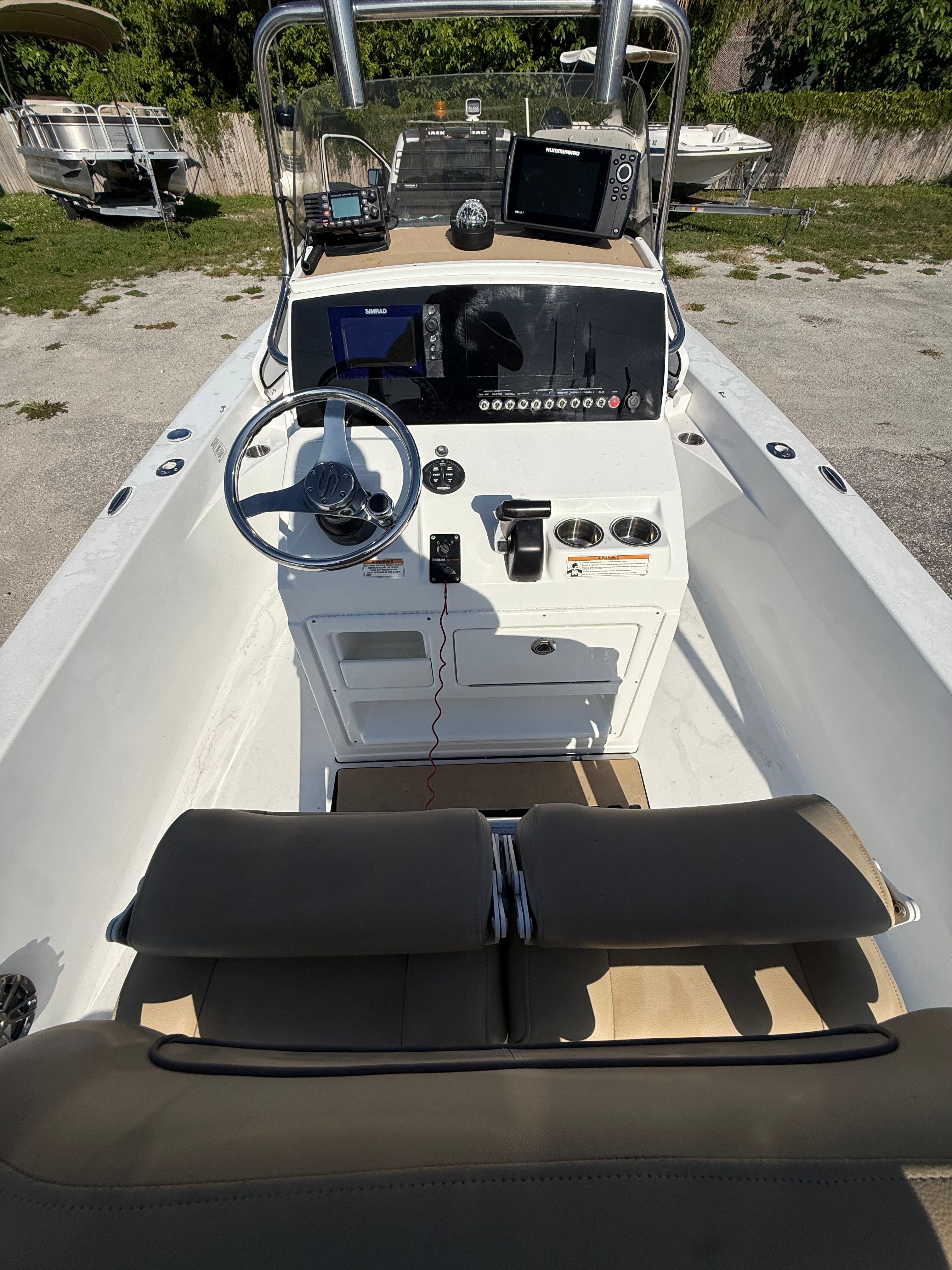 The image shows the cockpit of a 2016 Sportsman Masters 227 Bay Boat with a helm console and seating.