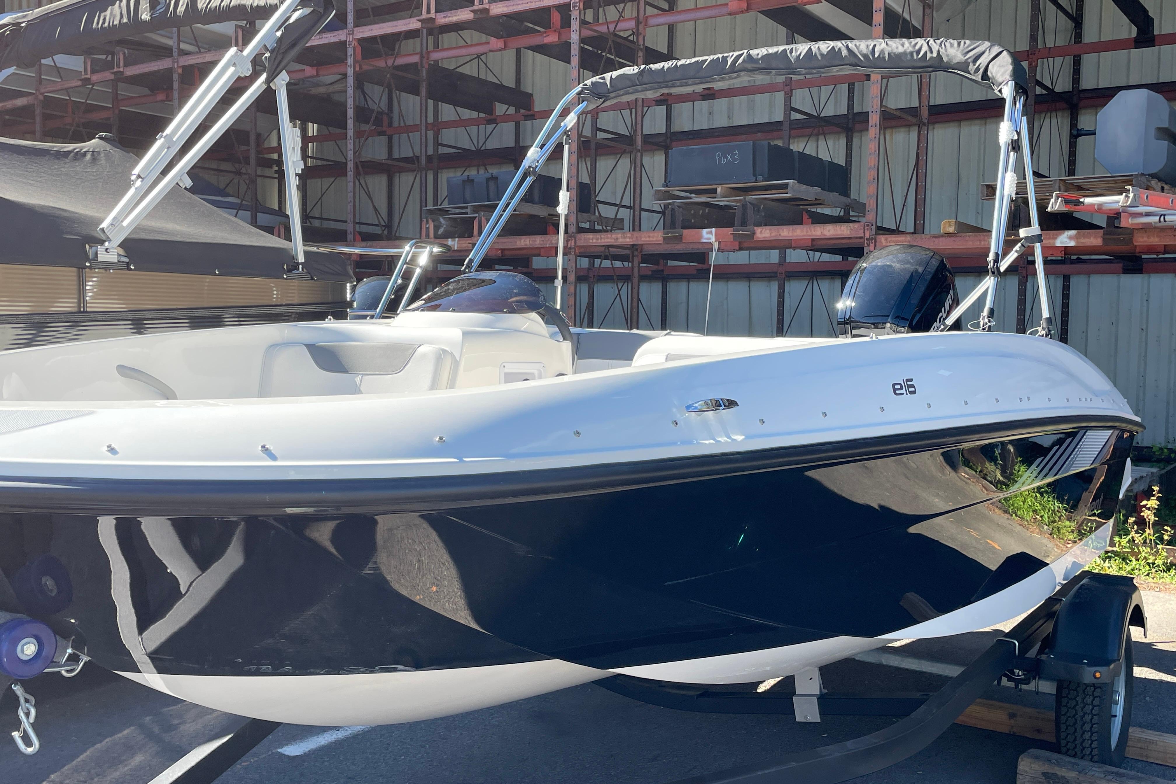 2026 Bayliner Element E16 boat in storage, featuring sleek design and modern features.