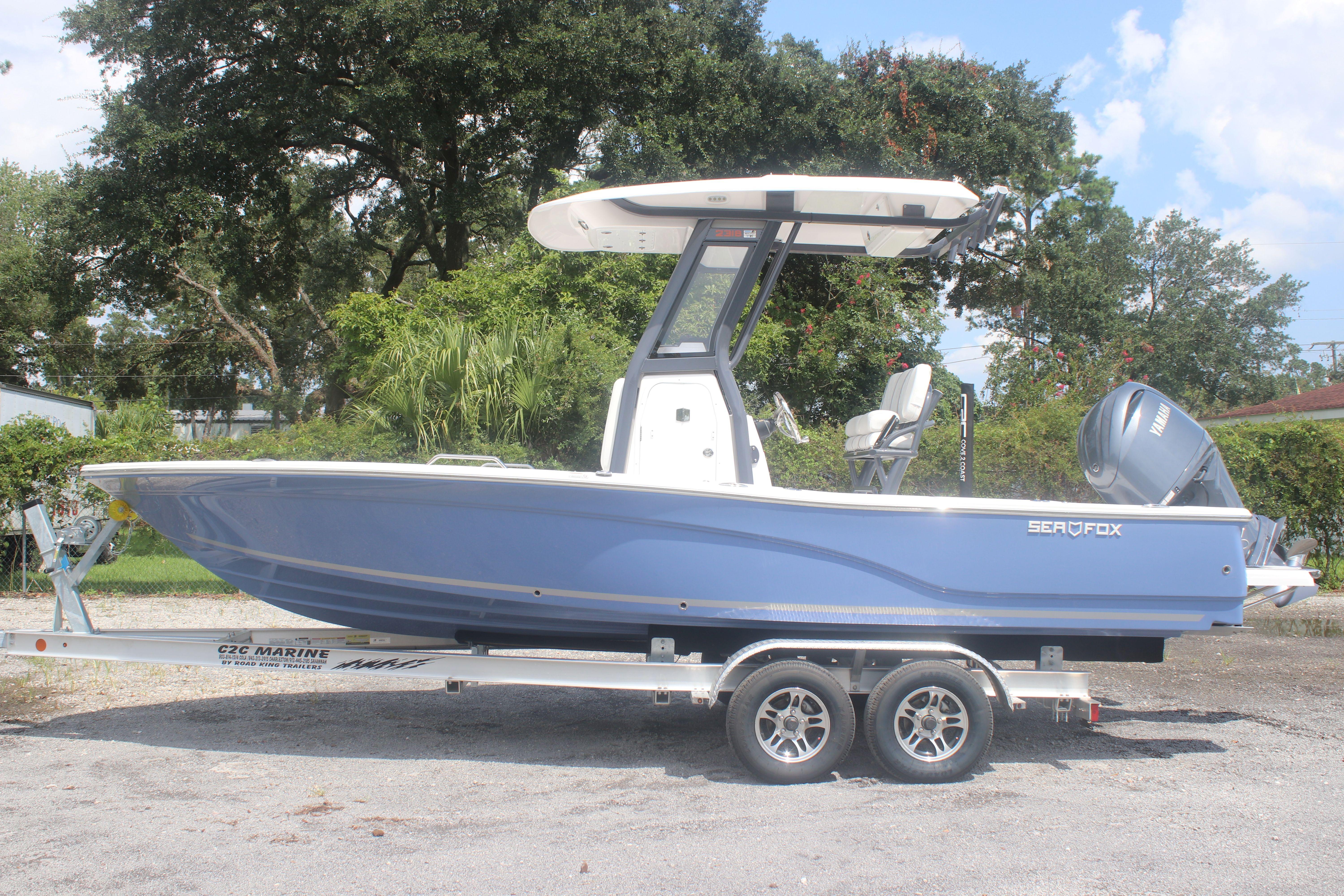 2025 Sea Fox 231 Bay Fox boat on trailer, parked outdoors.