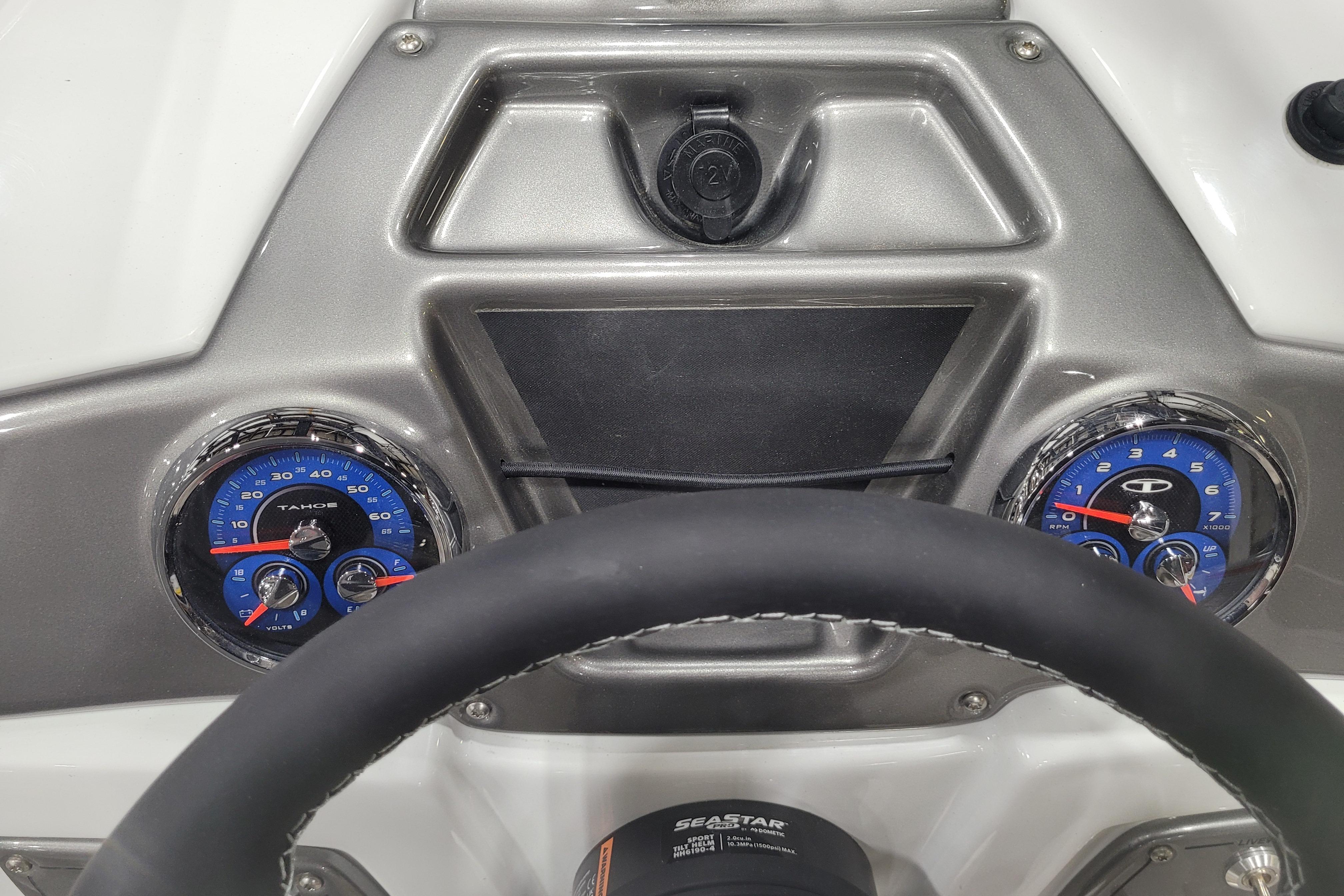 Dashboard of a 2026 Tahoe 2150 boat with steering wheel and gauges.
