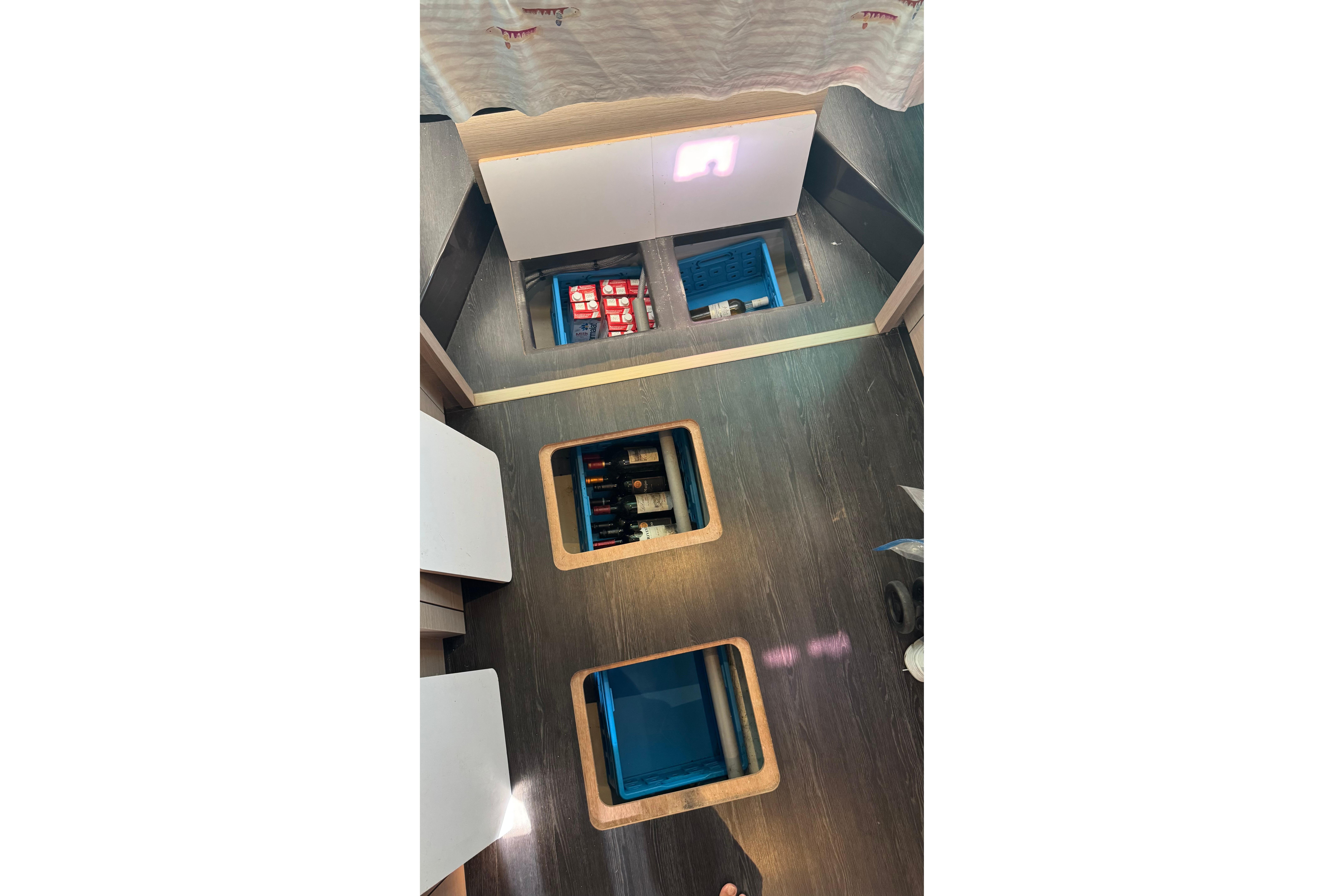 Interior view of 2020 Fountaine Pajot Saona 47 yacht with open floor storage compartments.