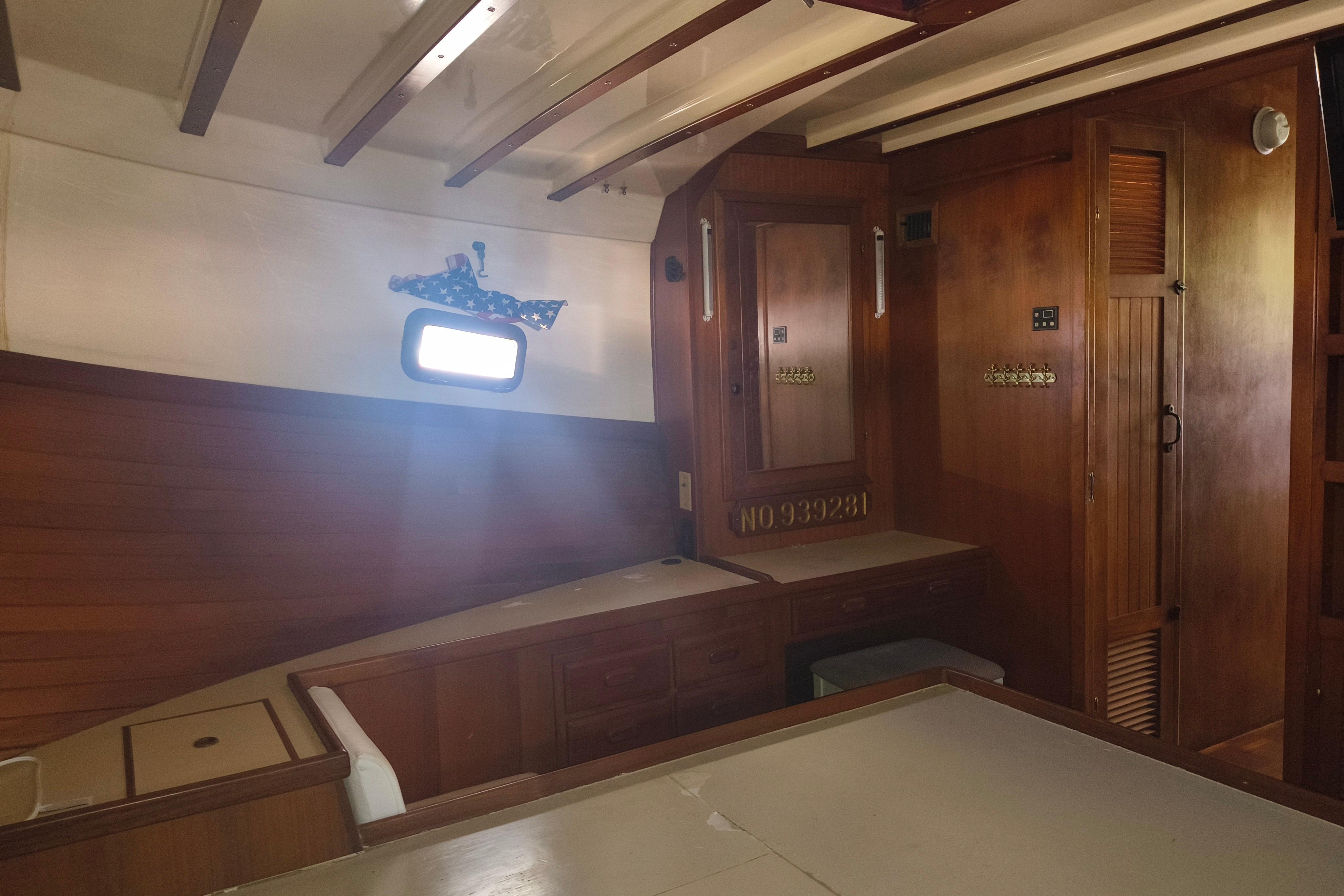 Interior of a 1984 Kadey-Krogen Manatee boat with wooden furnishings and a small window.