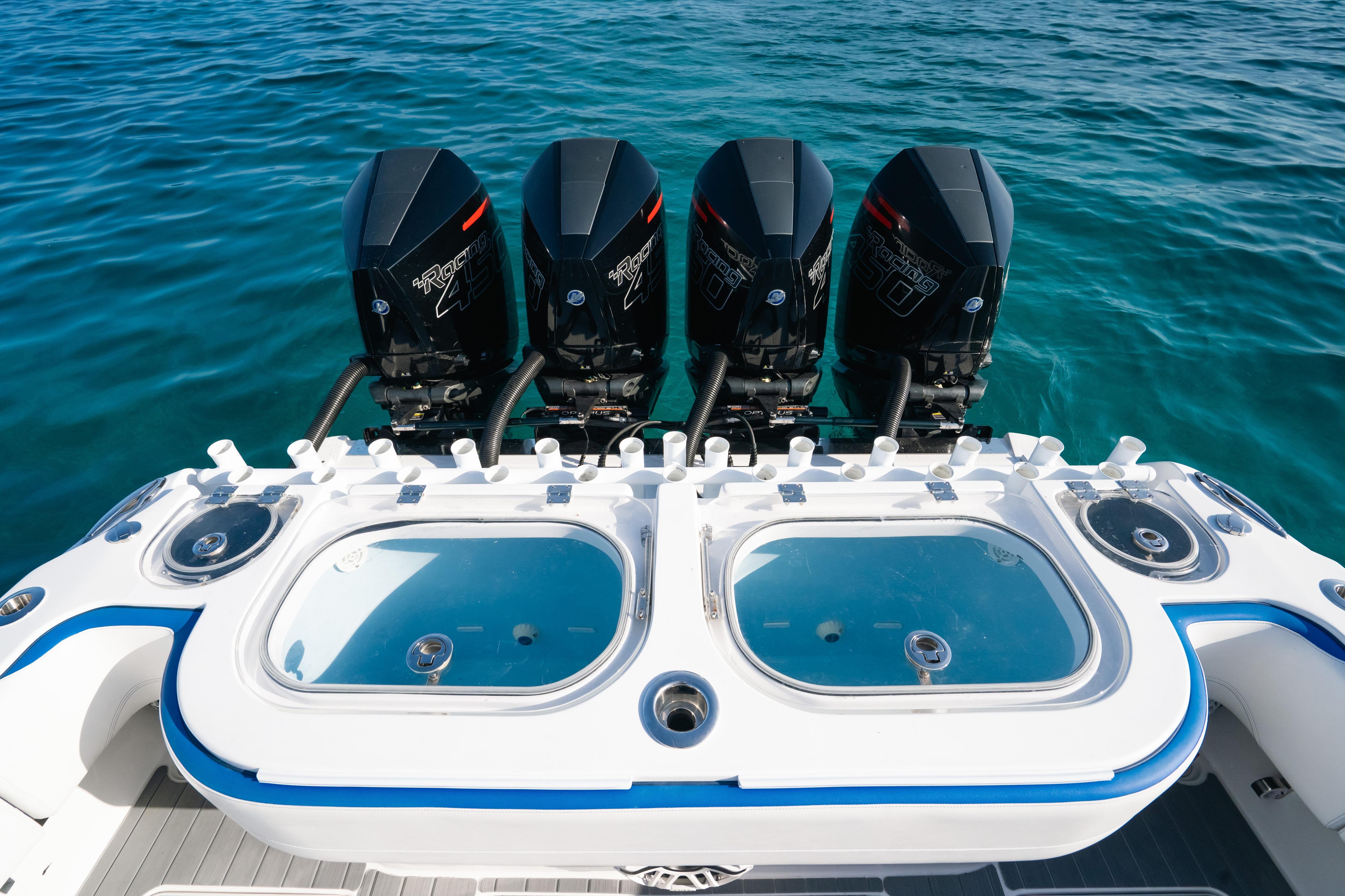 2022 Nor-Tech 392 Super Fish boat with four powerful outboard engines on clear blue water.