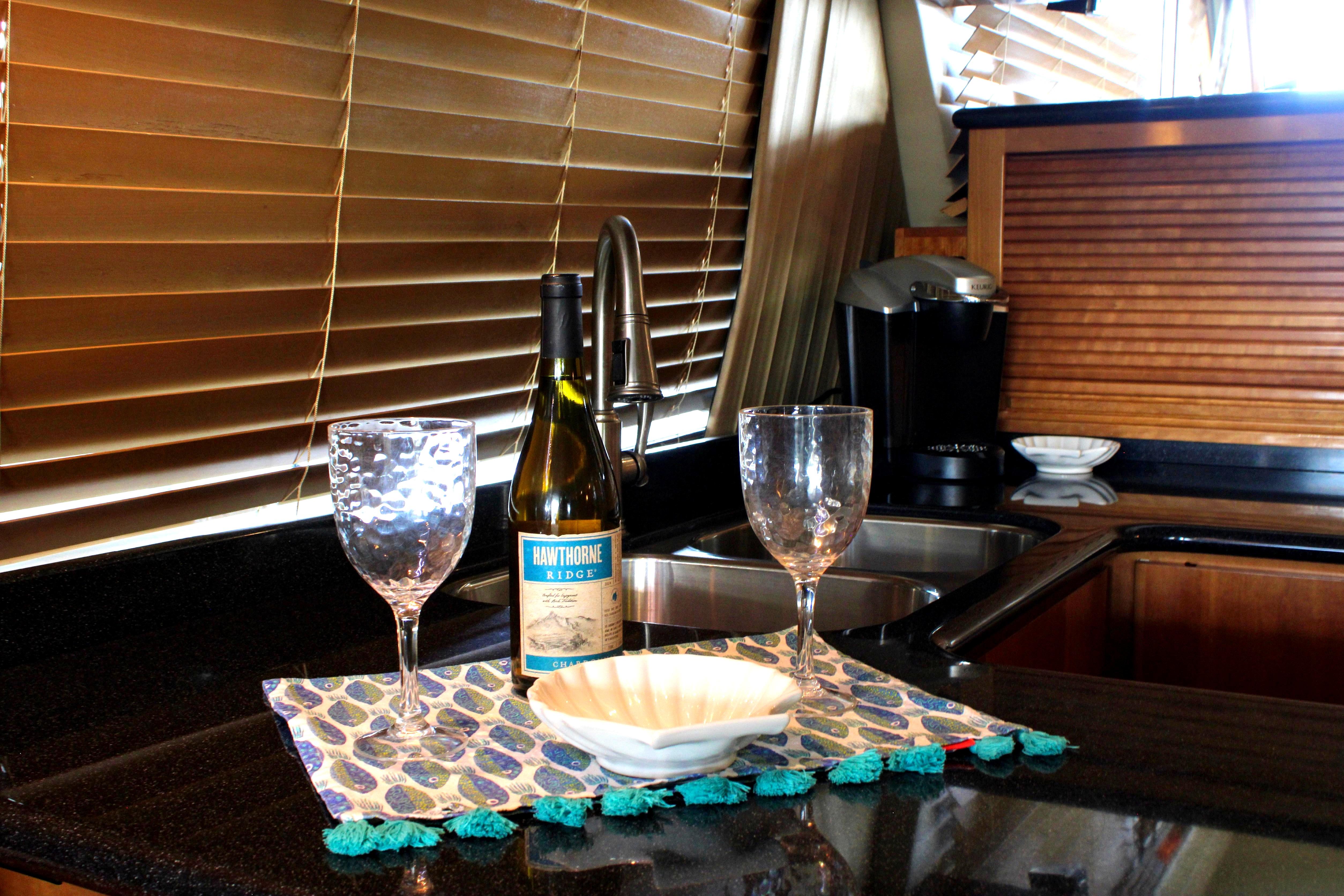 Luxury yacht kitchen with wine bottle, glasses, and elegant decor, Navigator 5100, 2007 model.