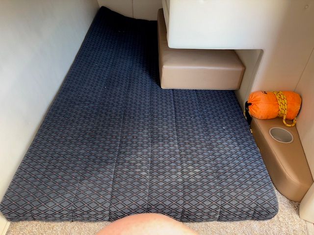 Interior of a 2008 Bayliner Discovery with padded sleeping area.
