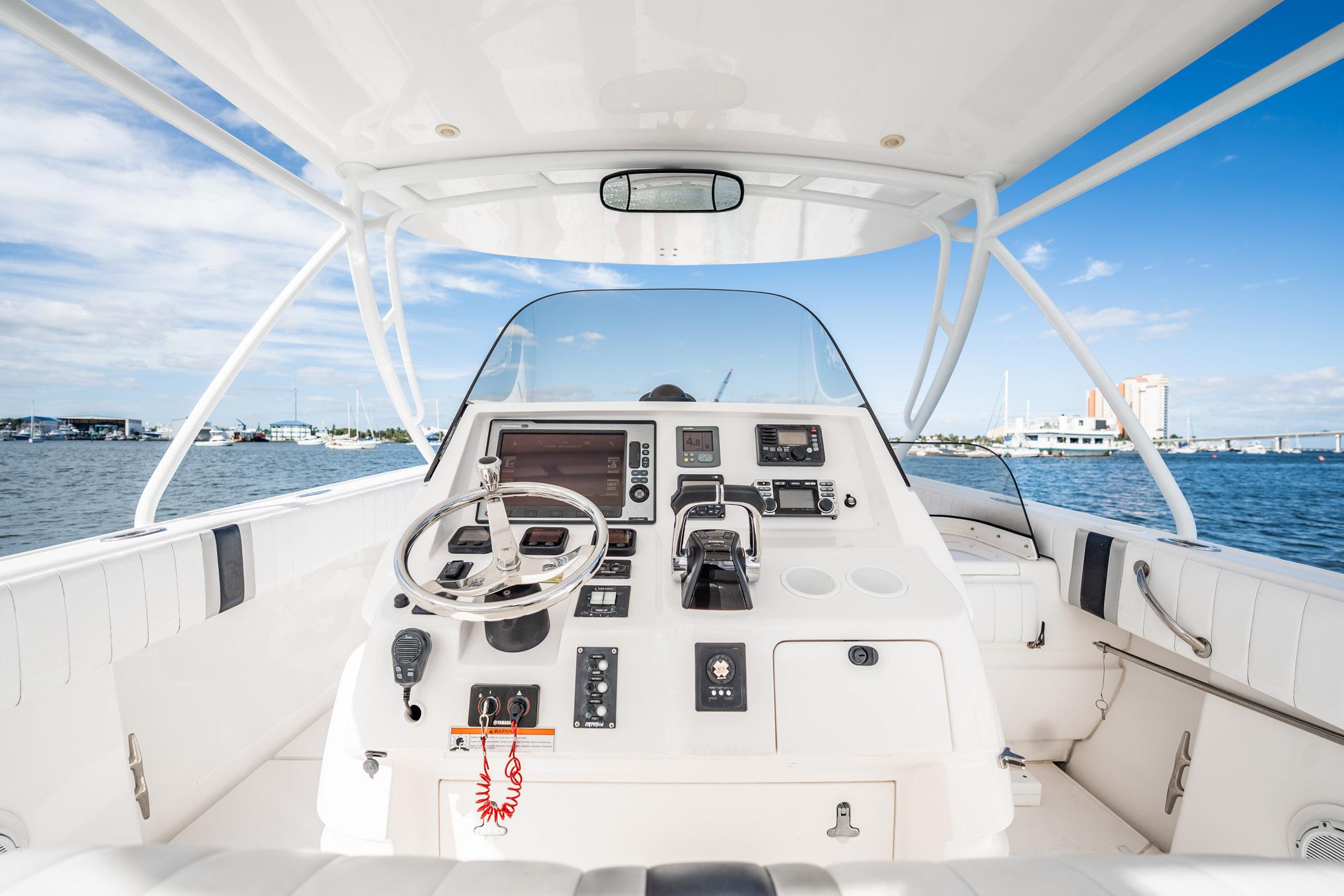 2011 Intrepid 400 Center Console boat interior with steering wheel and control panel.