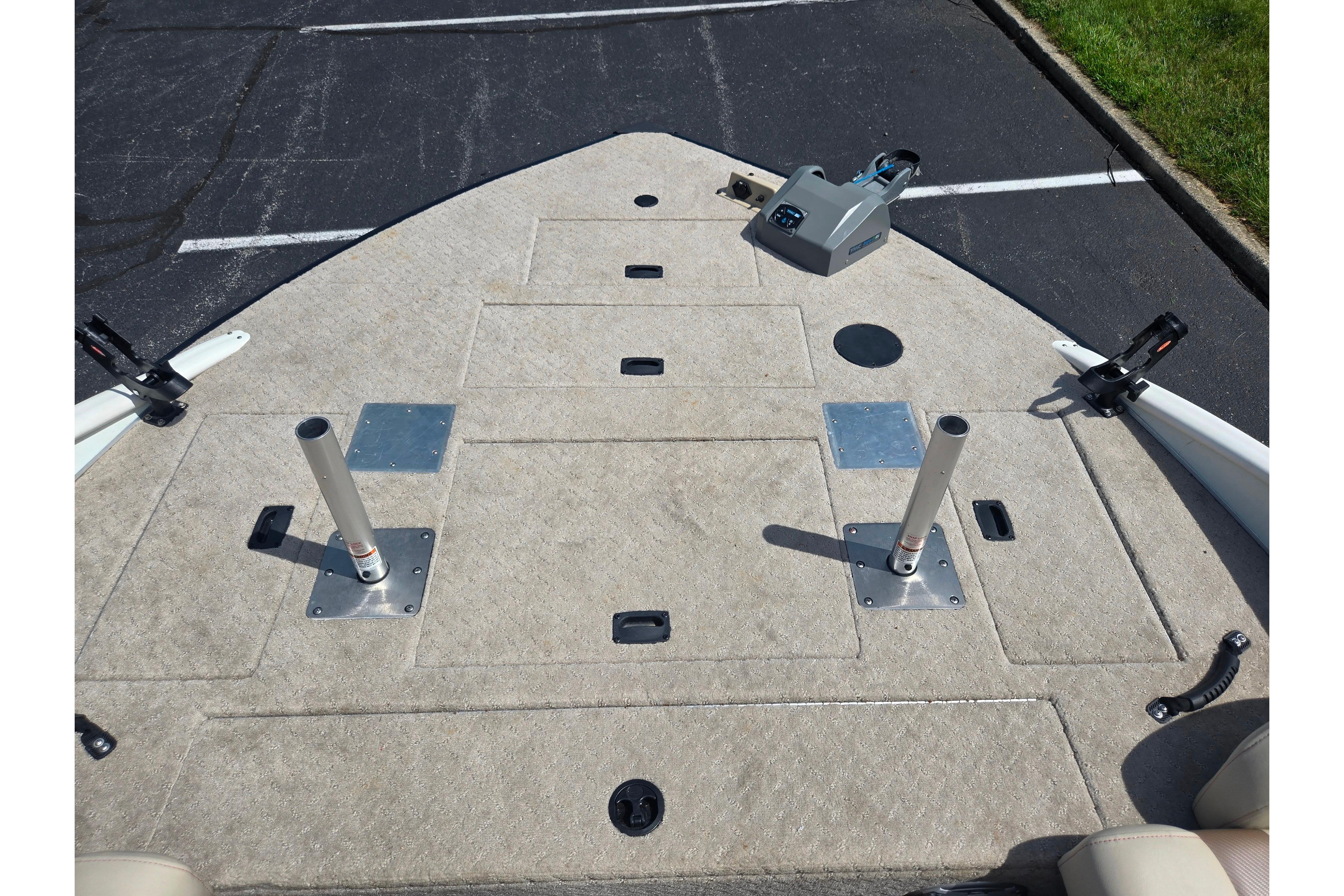 2015 Lowe Sport Deck 224 boat deck with fishing rod holders and storage compartments.
