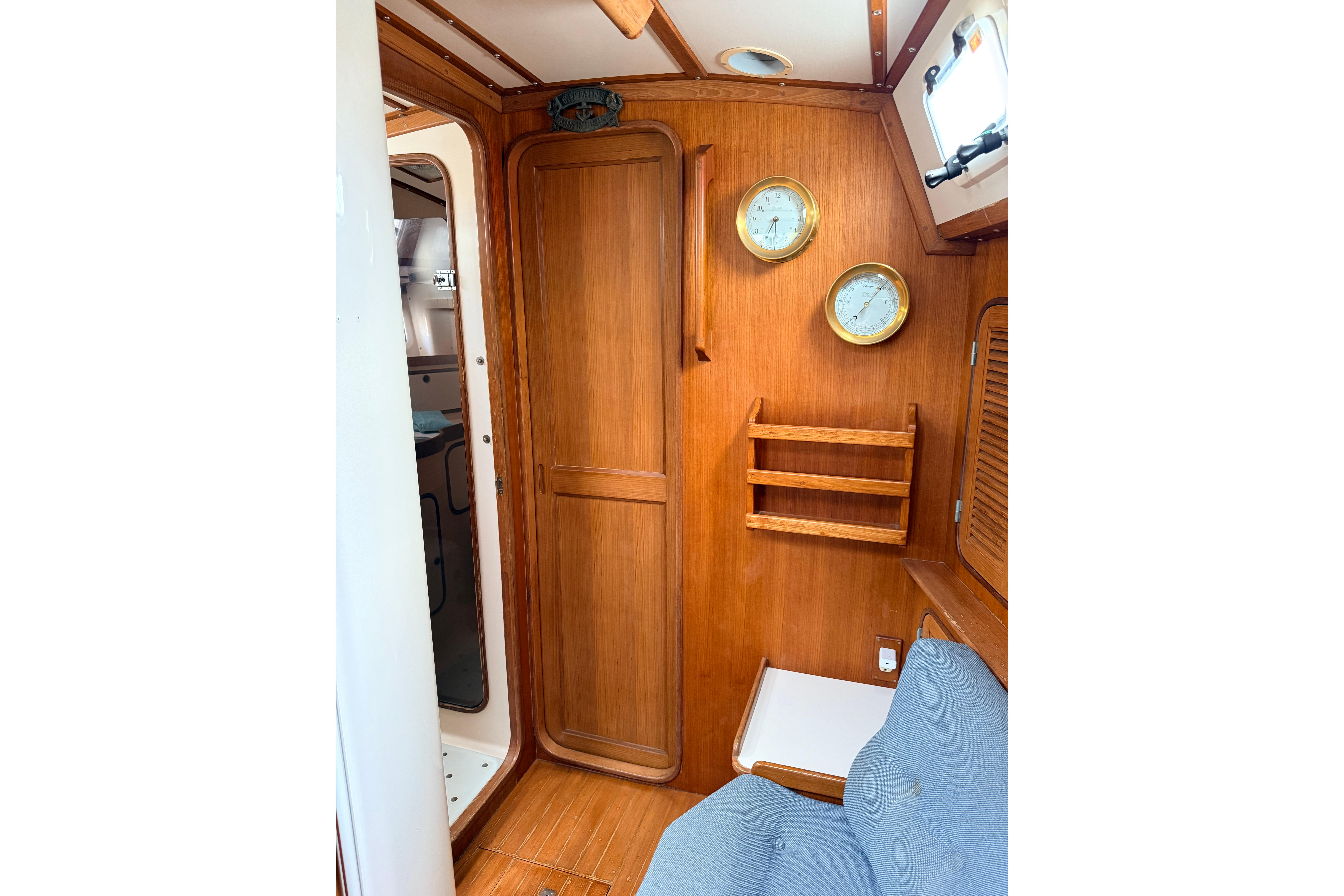 Interior of 1987 Norseman 400 sailboat with wooden cabinetry and nautical instruments.