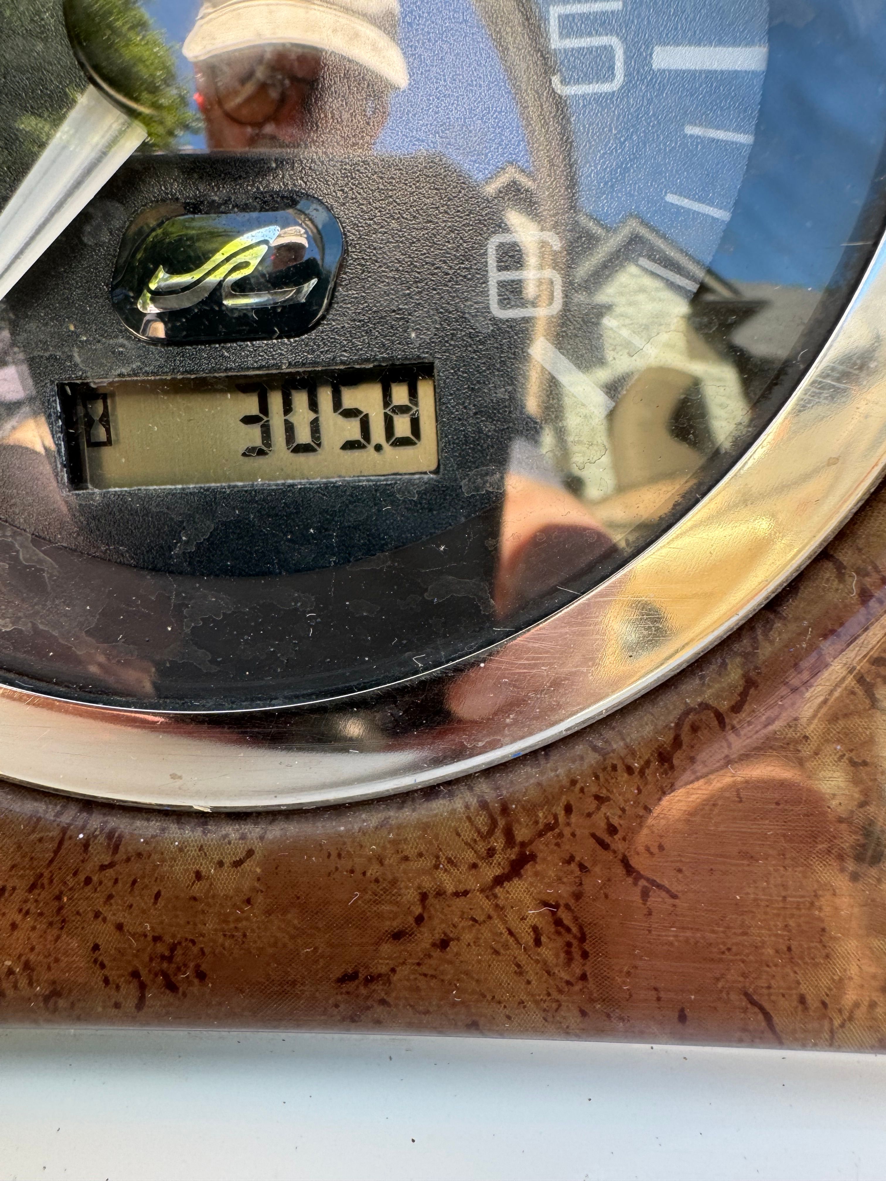 Tachometer of a 2001 Sea Ray 240 Sundeck boat showing 305.8 hours.