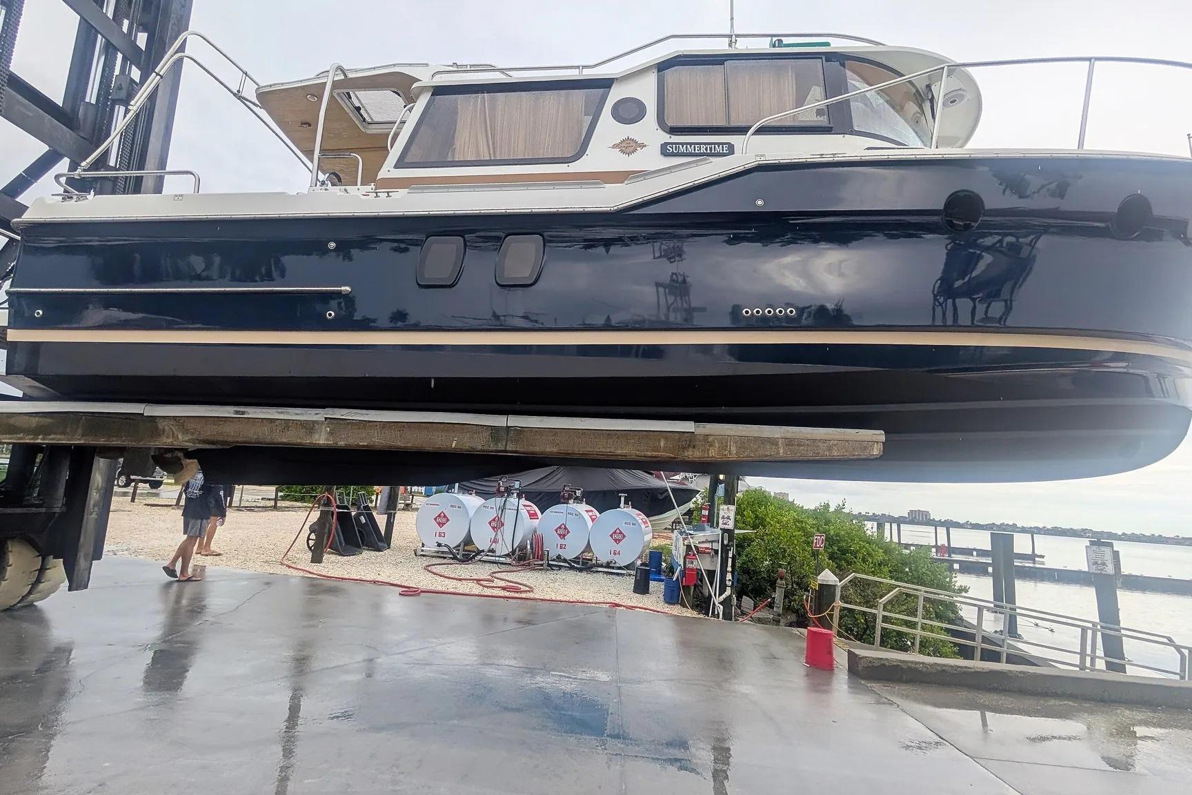 2015 Ranger Tugs R-29 S boat lifted at marina, showcasing sleek design.