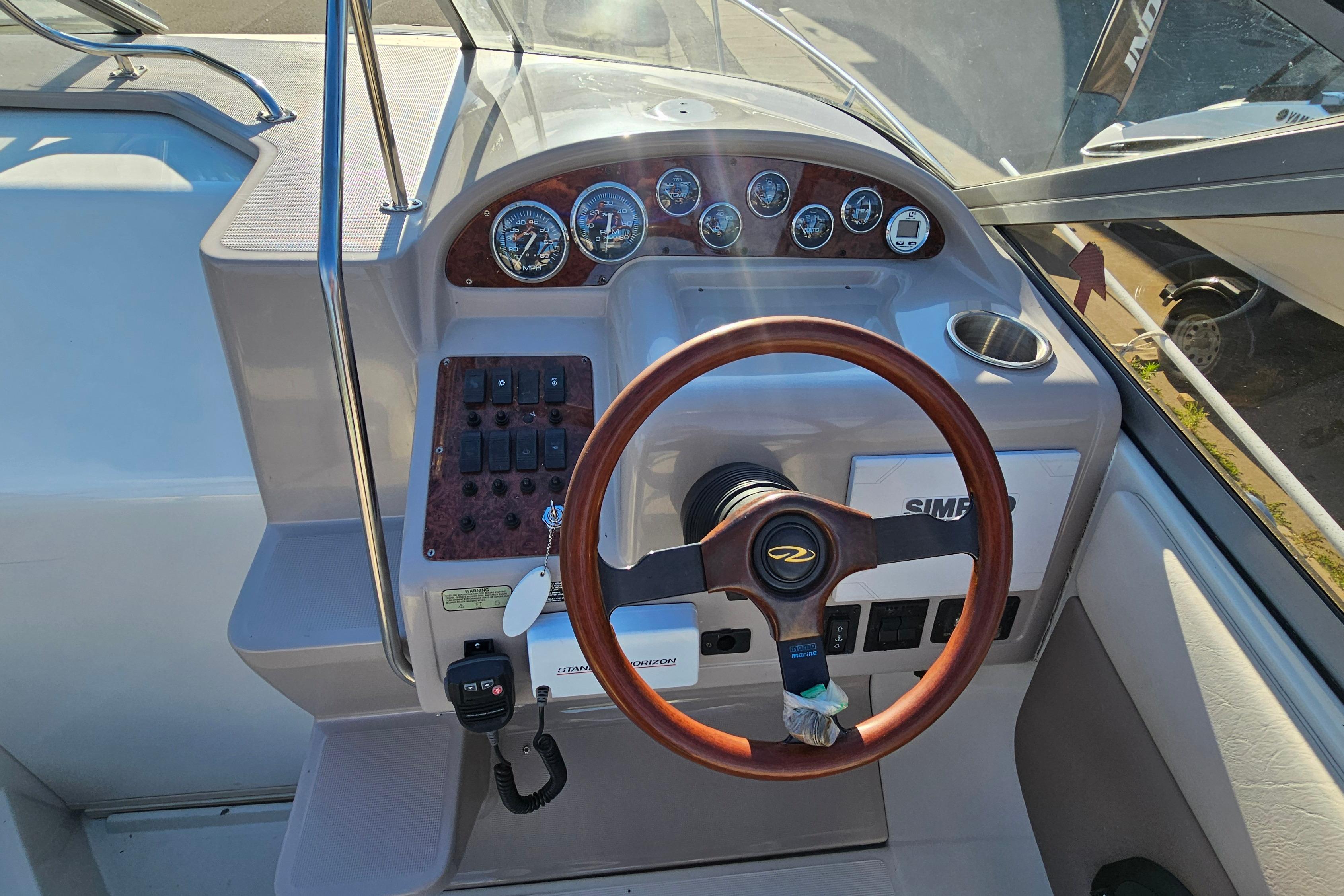 1999 Regal Commodore 258 boat dashboard with steering wheel and instrument panel.