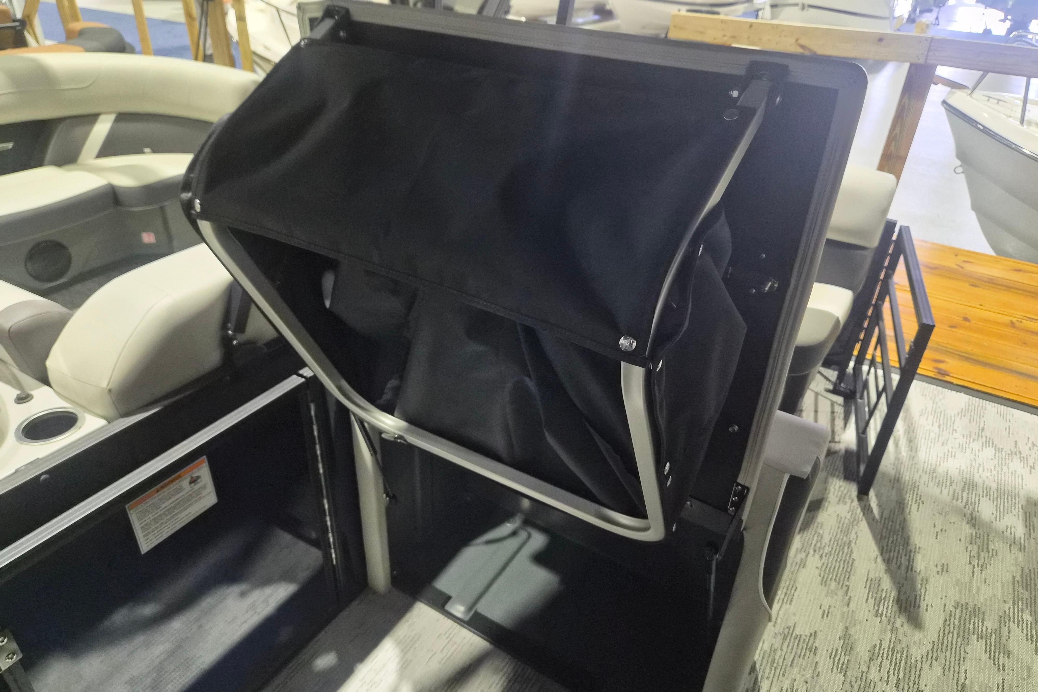 2026 Sylvan R-22 LZ DH boat interior with seating and storage compartment.
