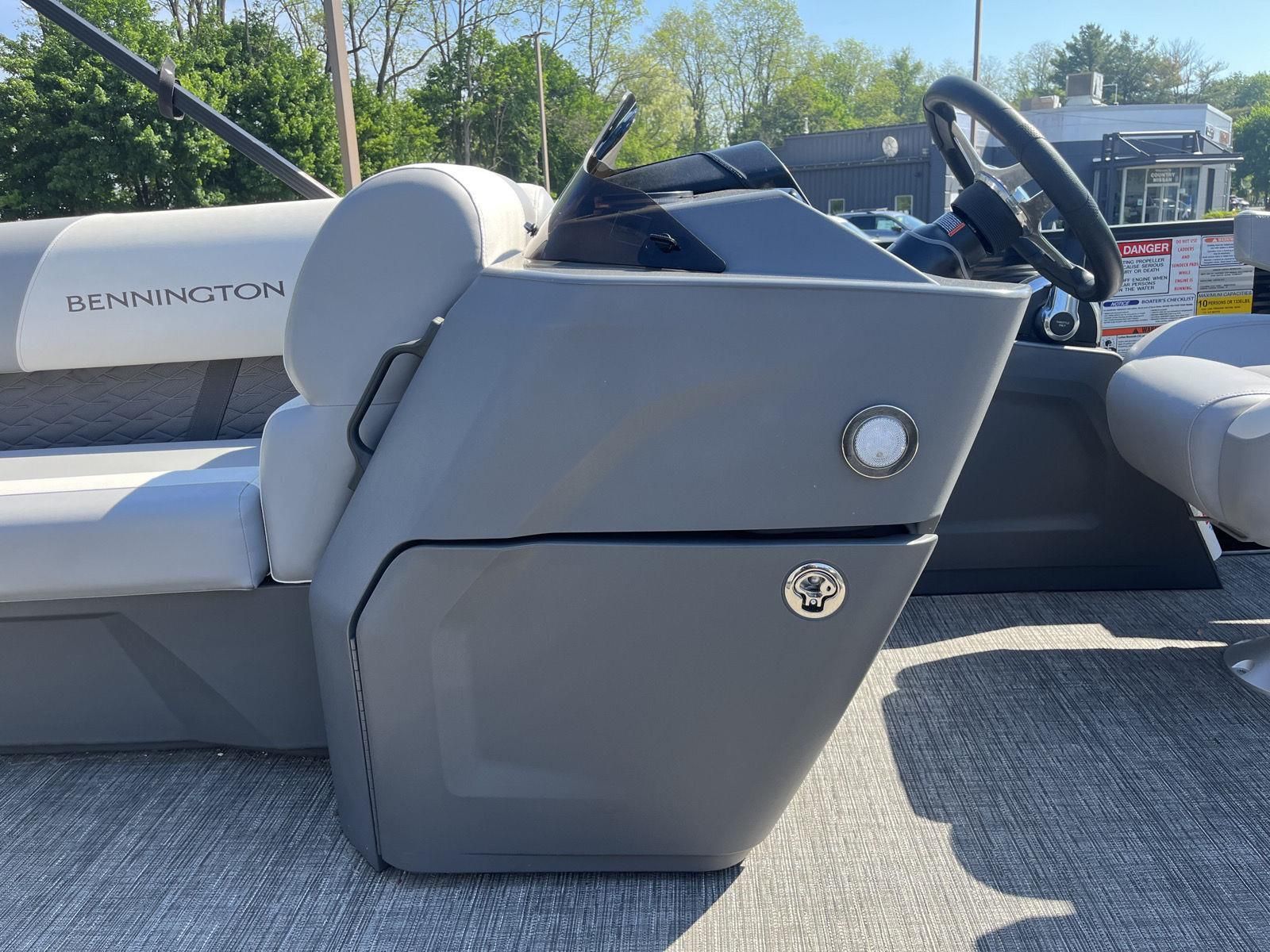 The image shows the helm of a 2025 Bennington S20 boat with gray upholstery.