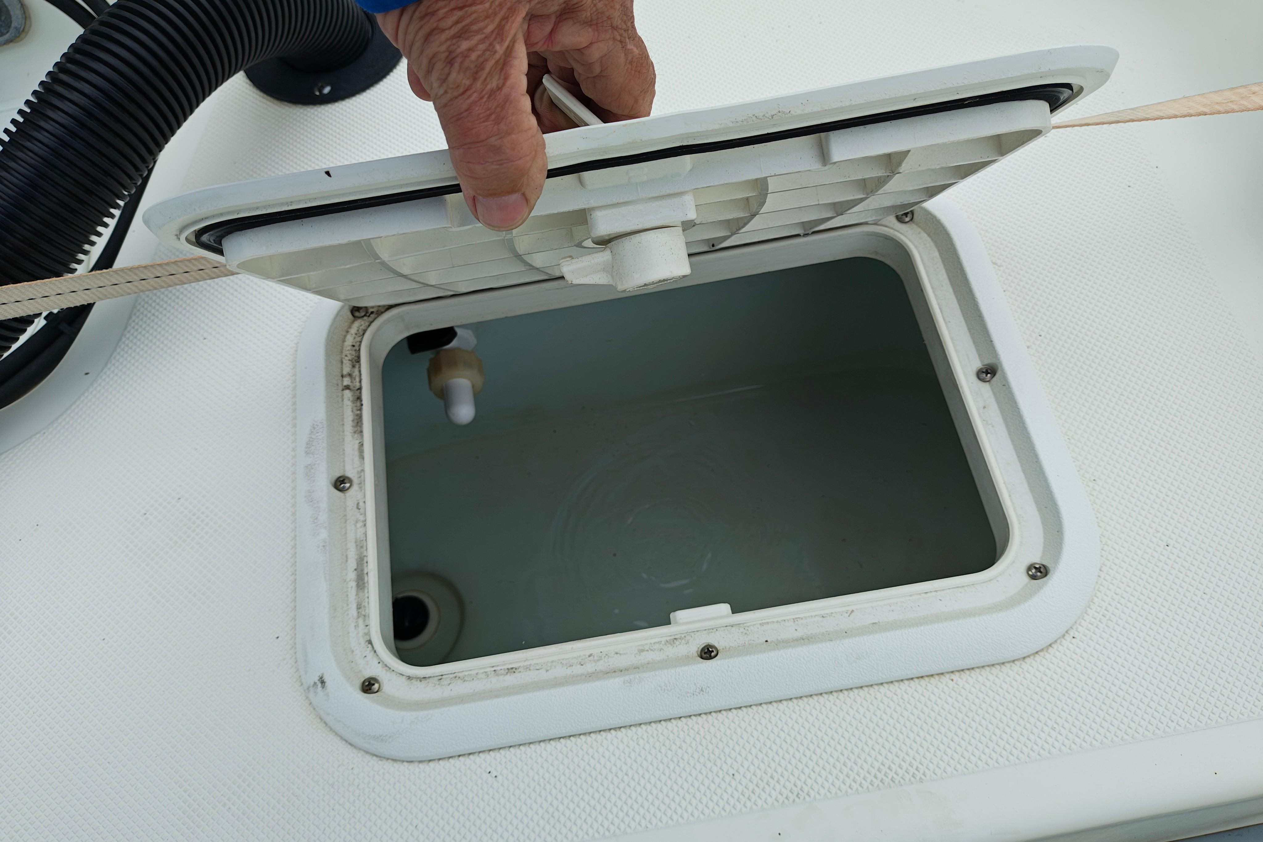 Open hatch on a 2018 Sundance B20CCR boat, showing interior compartment.