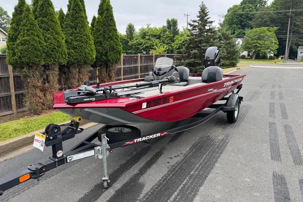 2022 Tracker Pro 170 boat on trailer, parked on a residential street.
