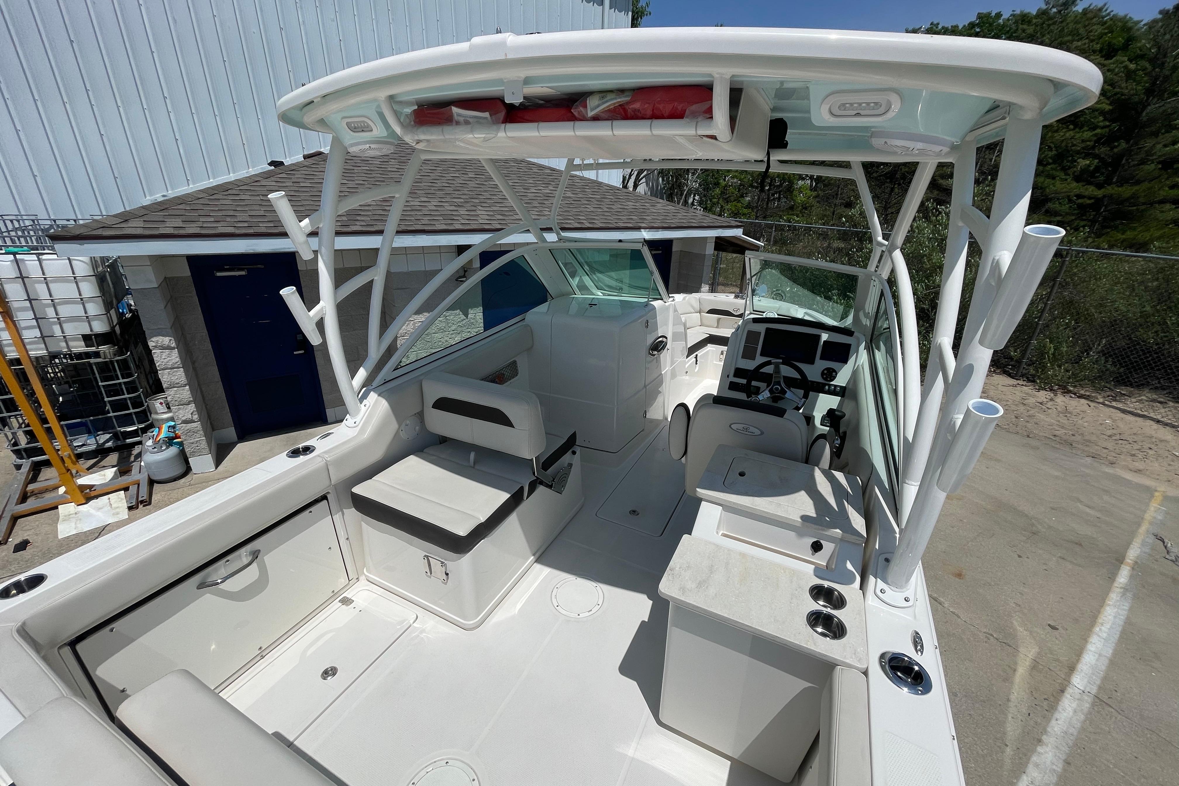 2022 Sailfish 245 DC boat interior with seating, helm, and storage compartments.