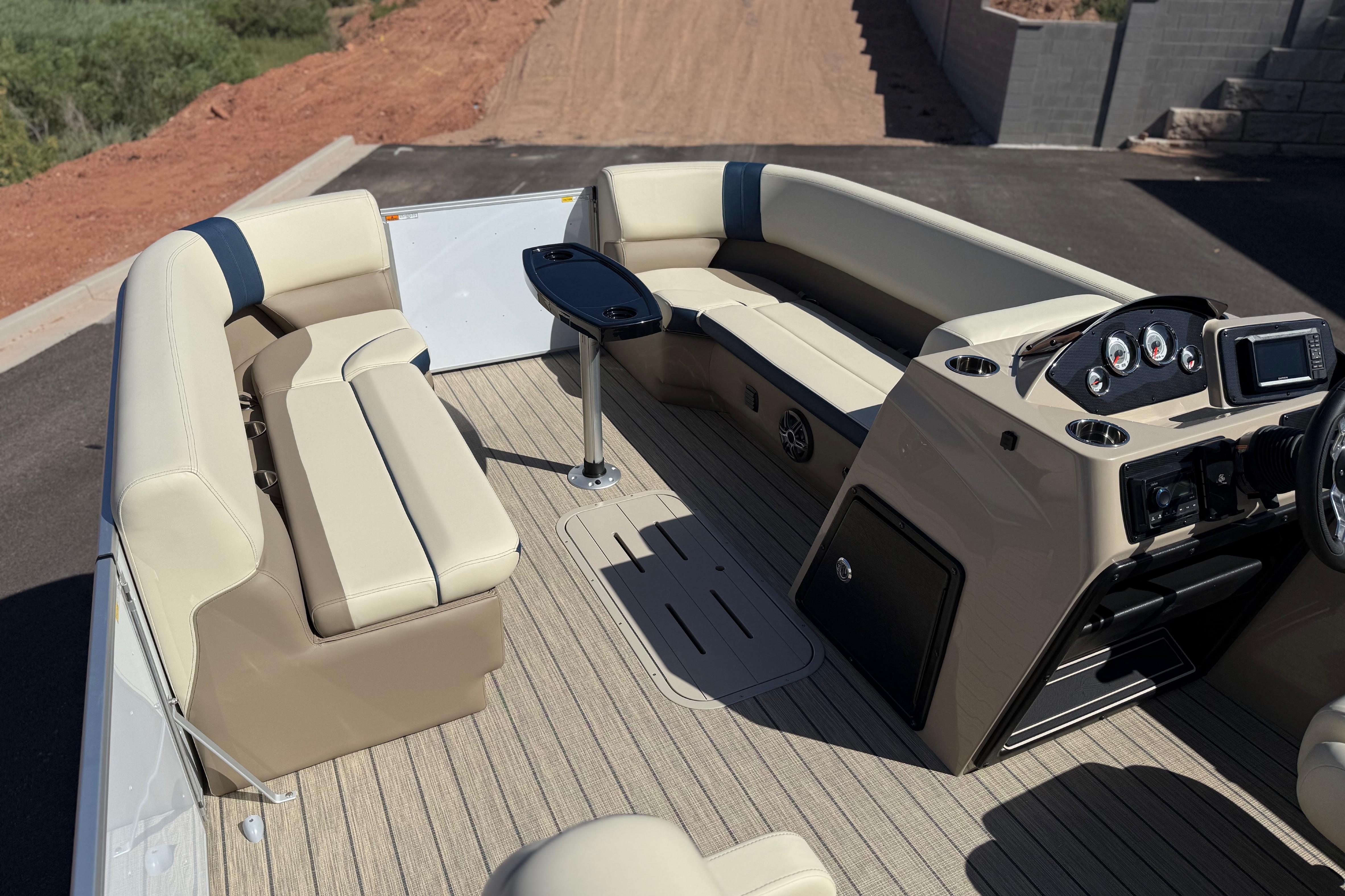 Luxurious interior of 2026 SunCatcher Select 322SL pontoon boat with plush seating and modern dashboard.