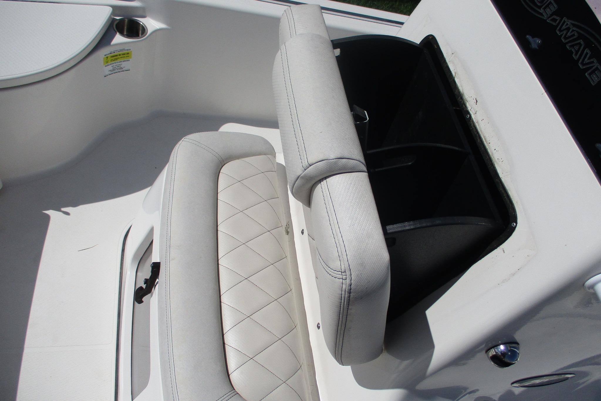 2021 Blue Wave 2000 PureBay boat interior with cushioned seating and storage compartment.
