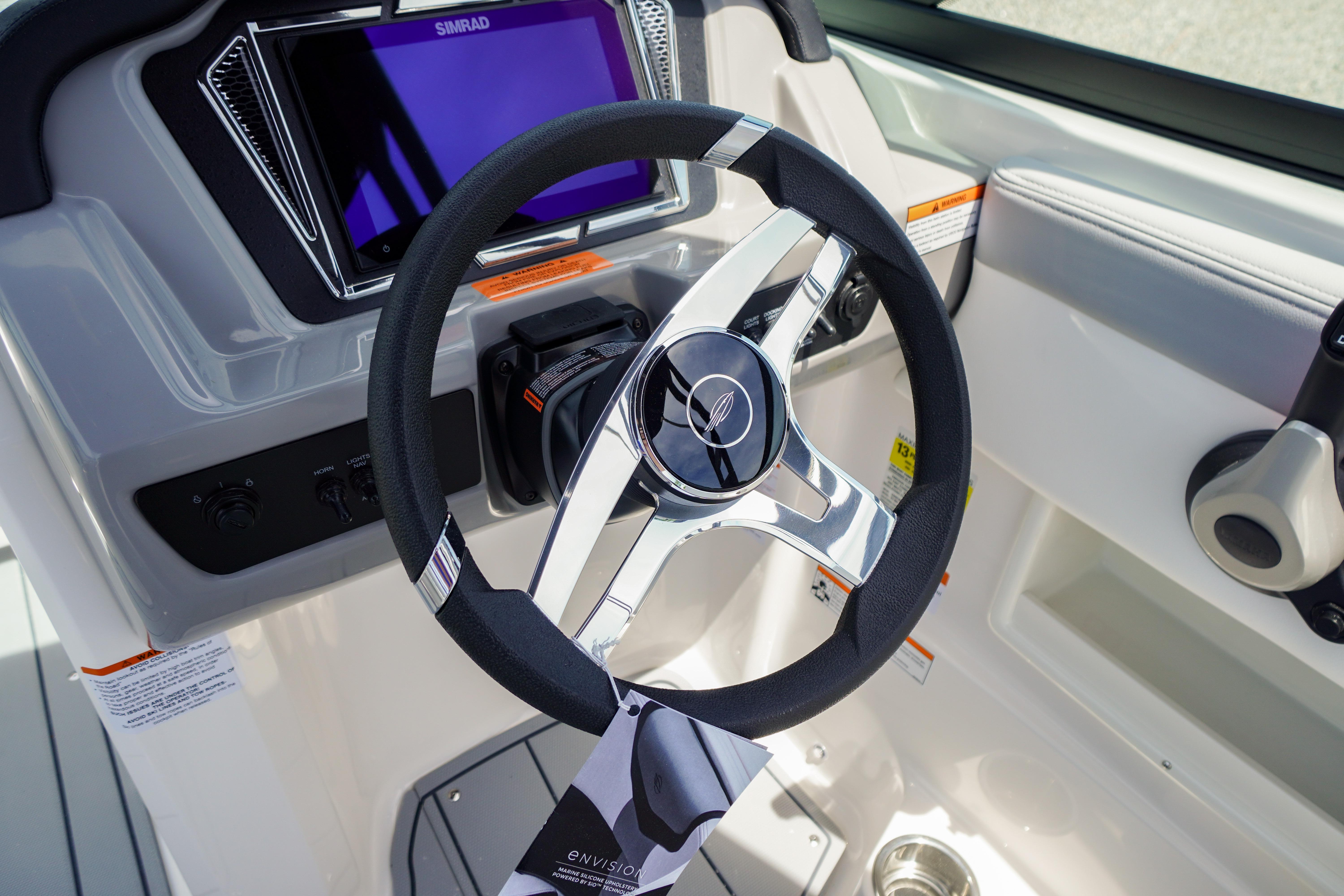 2026 Chaparral 23 SSi OB boat steering wheel and dashboard with modern controls.