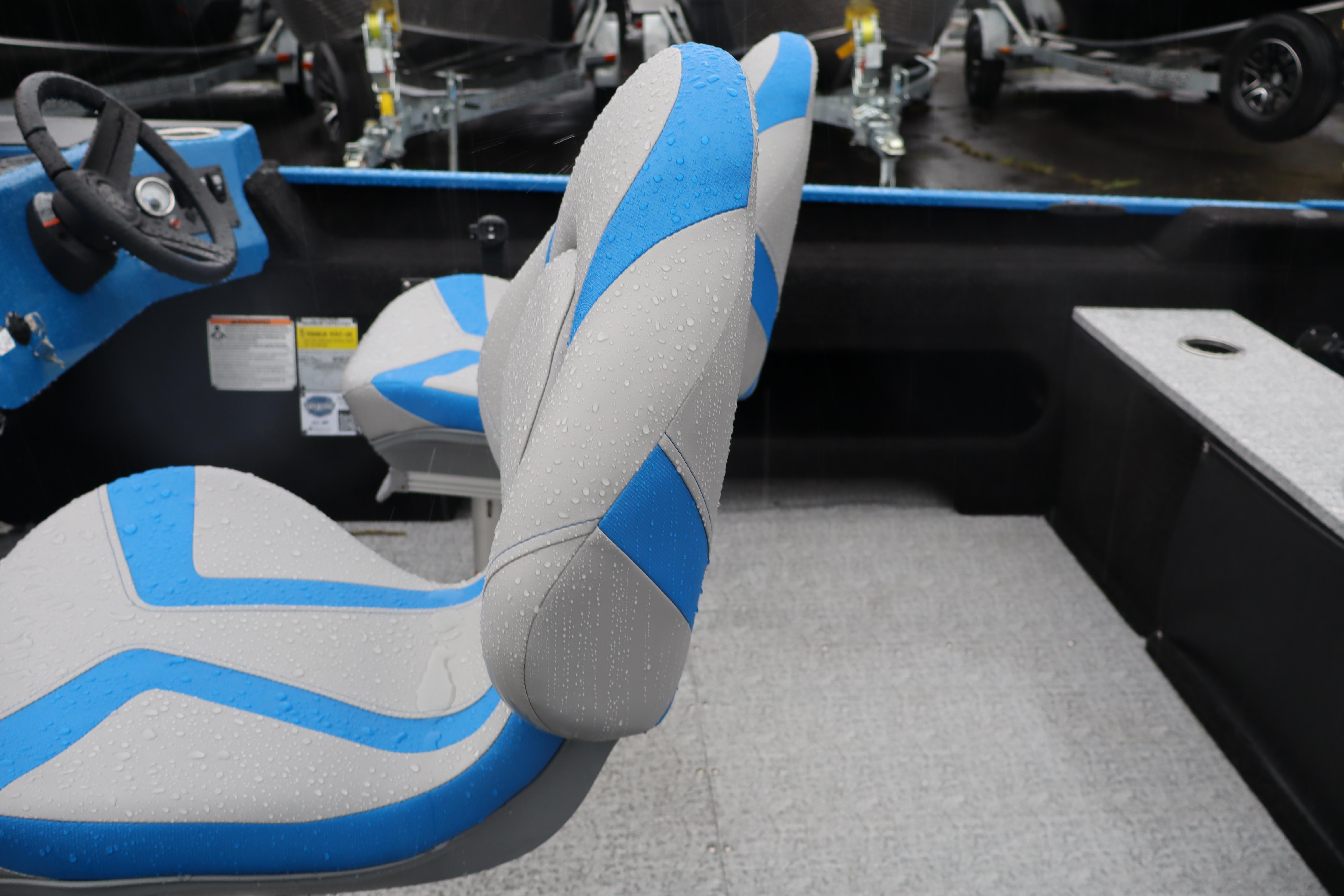 2026 Smoker Craft Lazer 161 boat interior with blue and gray seats, steering wheel visible.