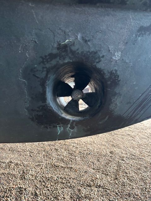 Close-up of a bow thruster on a boat hull.