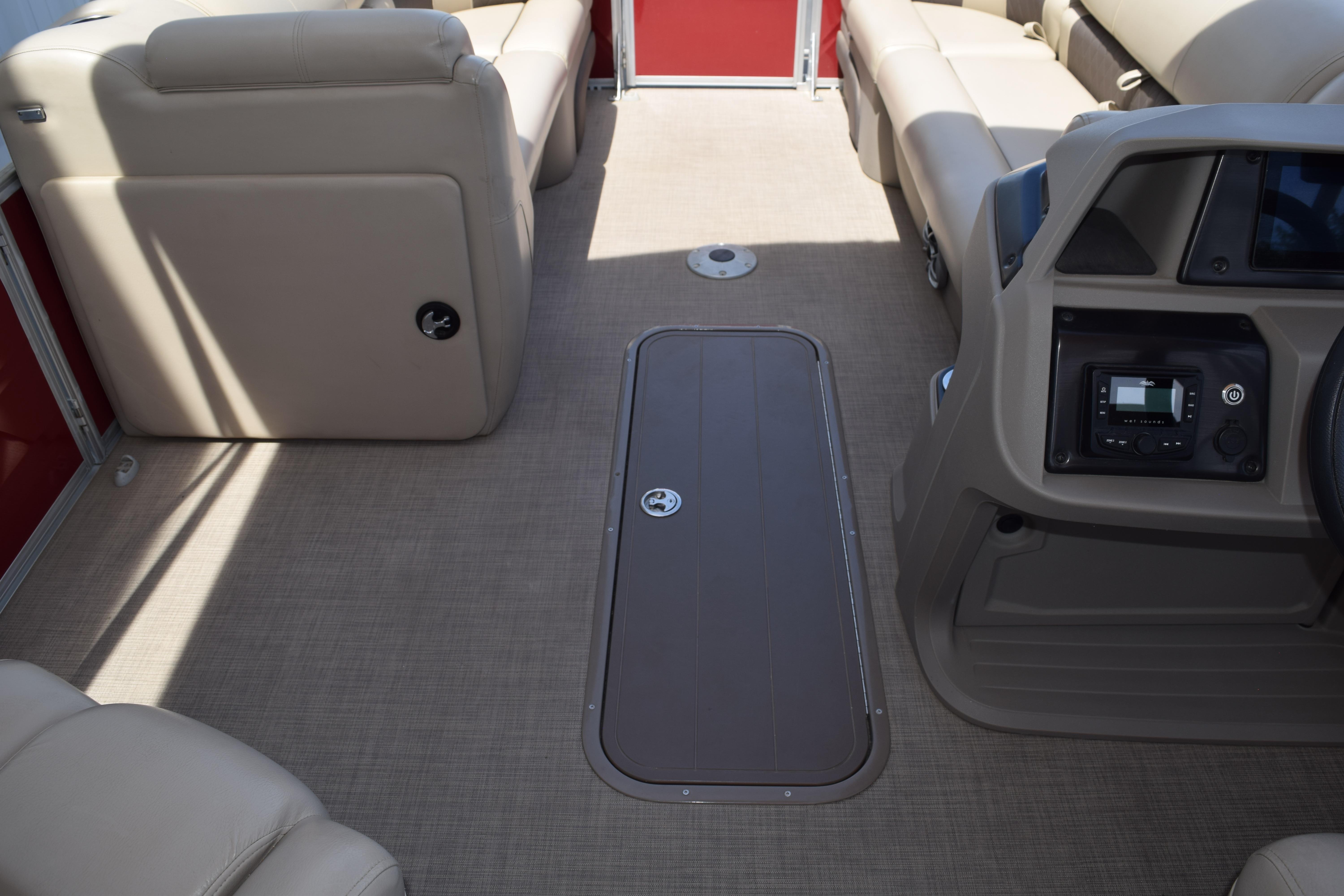 2025 Sun Tracker Party Barge 22 XP3 interior with beige seating and modern dashboard.