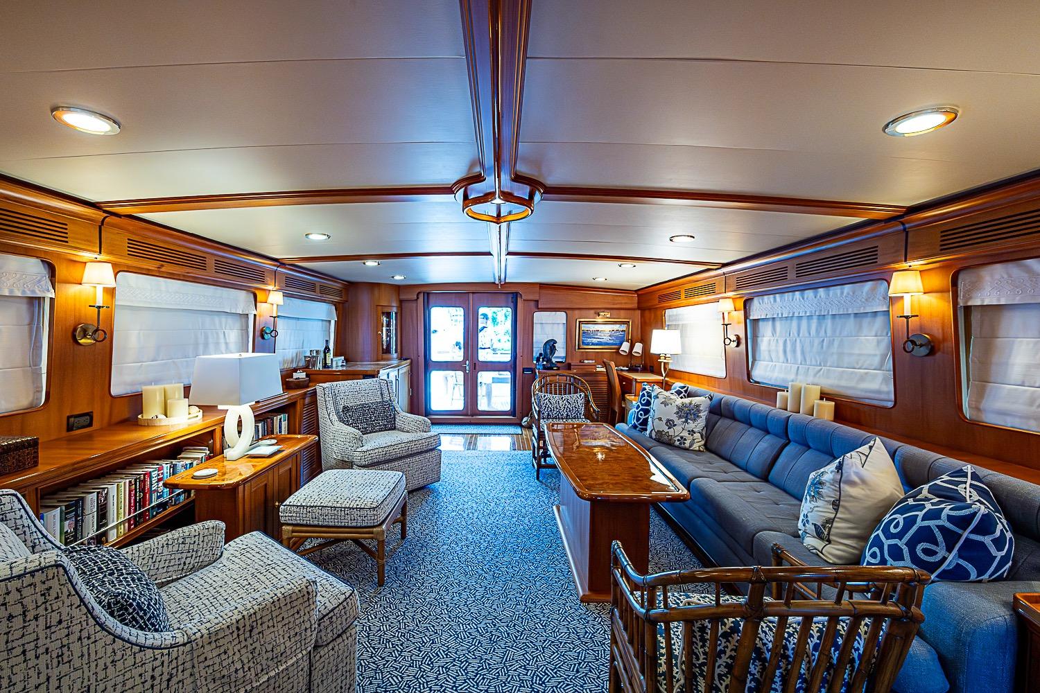 Luxurious interior of 2014 Marlow 80 Explorer yacht with elegant seating and wooden accents.