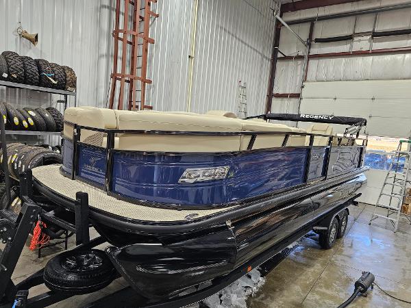 2024 Regency 250 DL3 pontoon boat in a storage facility.
