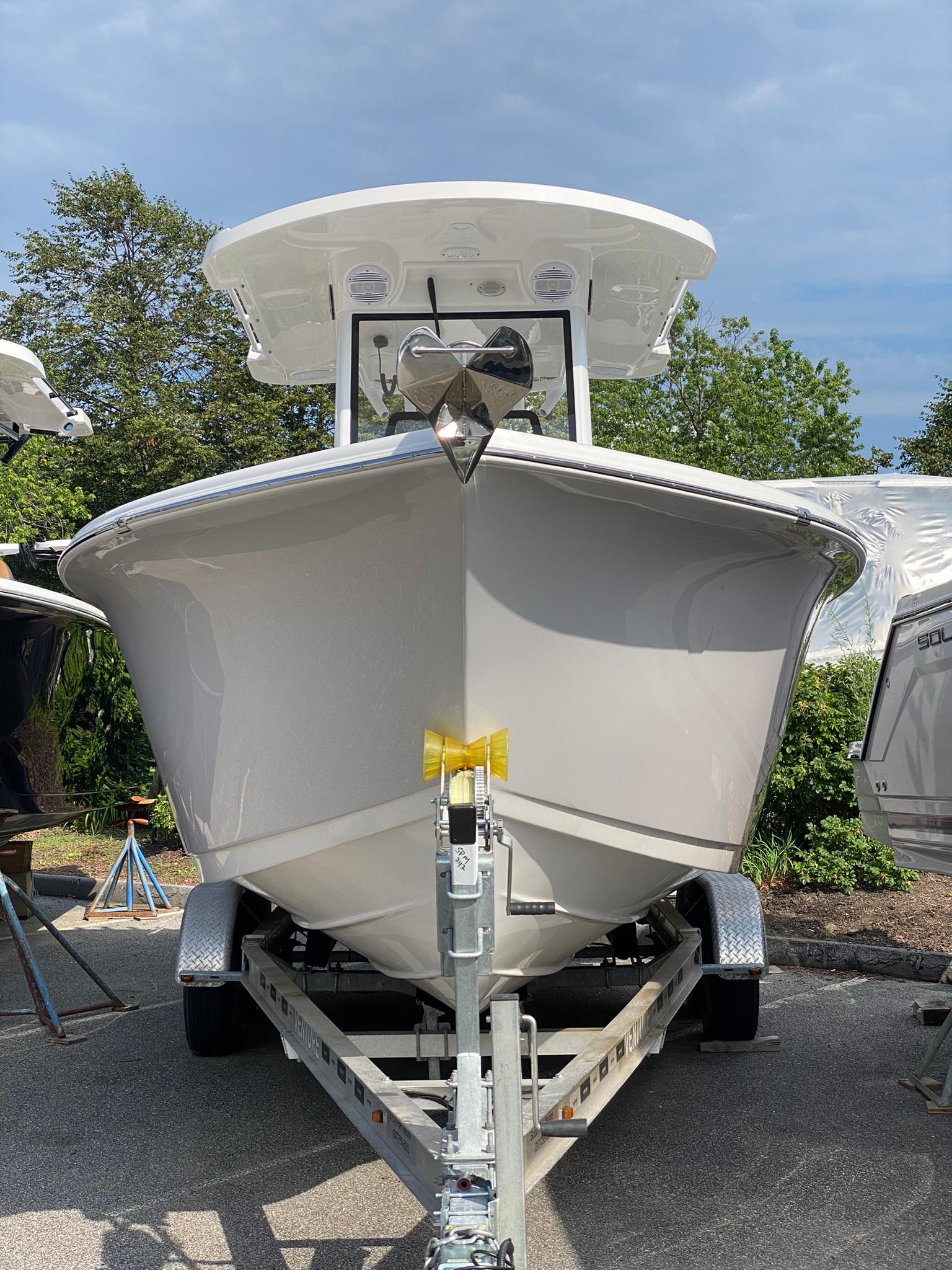 2025 Sea Pro 242 Center Console boat on trailer, front view, outdoors.