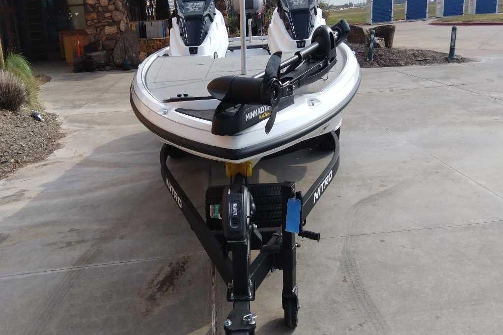 2026 Nitro Z19 XL boat on trailer, parked on concrete driveway.