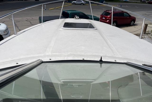 2003 Sea Ray 260 Sundancer boat deck view in a parking area.