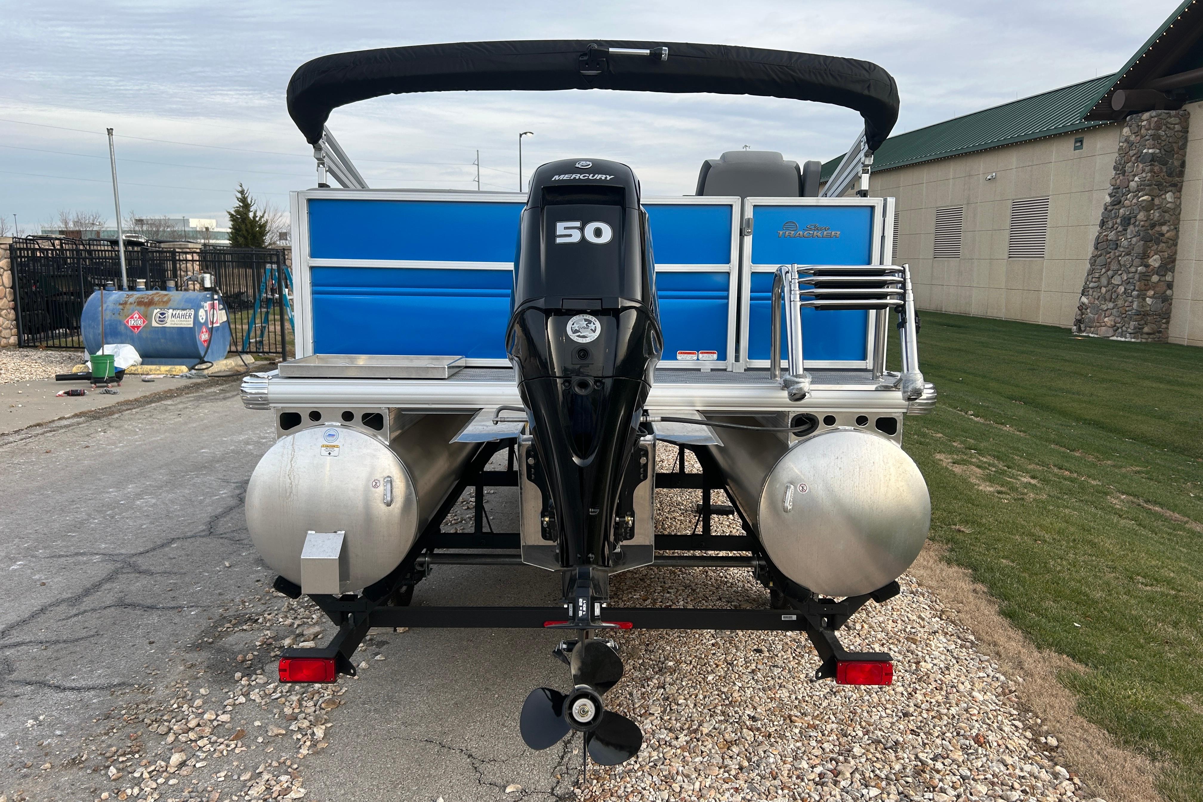 2026 Sun Tracker Party Barge 16 DLX pontoon boat with Mercury 50 engine, rear view.