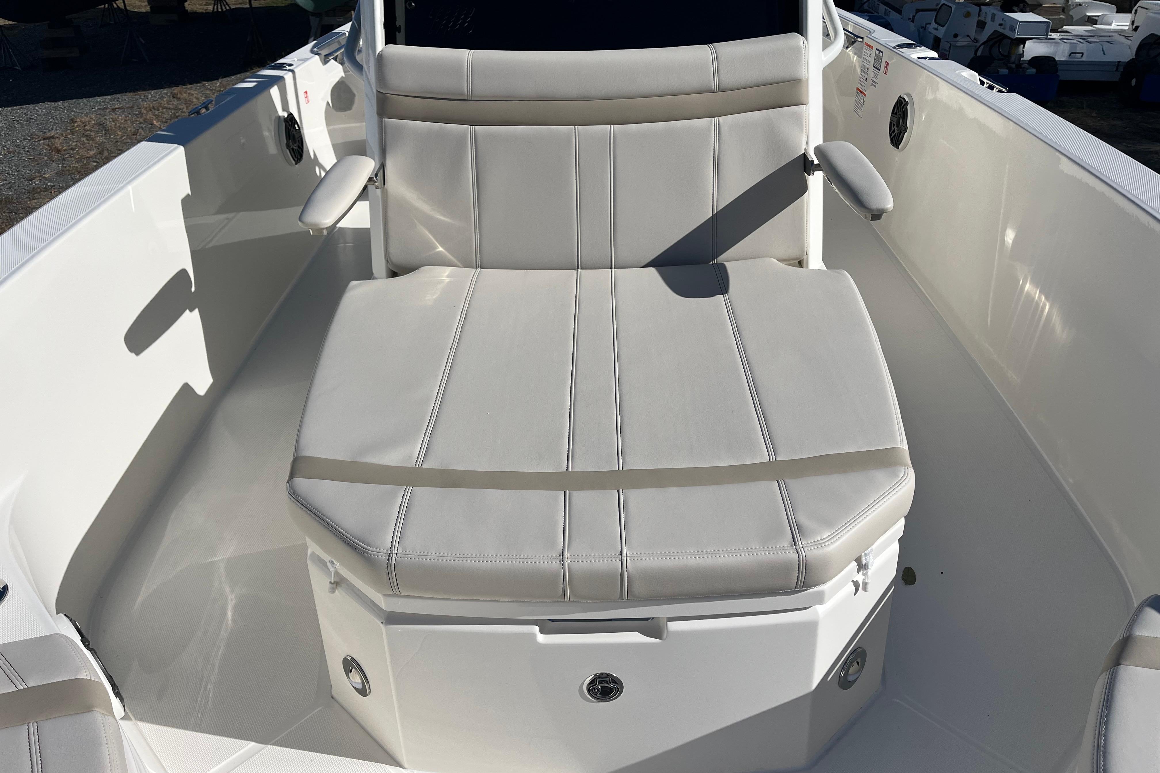 2026 Boston Whaler 280 Dauntless boat seat with white upholstery and armrests.