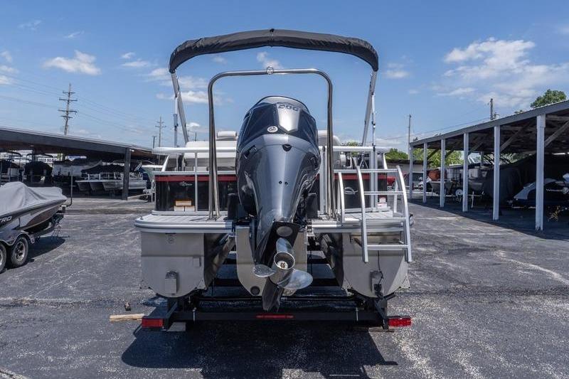 2026 SunCatcher Select 322SL pontoon boat with outboard motor, parked in a marina.