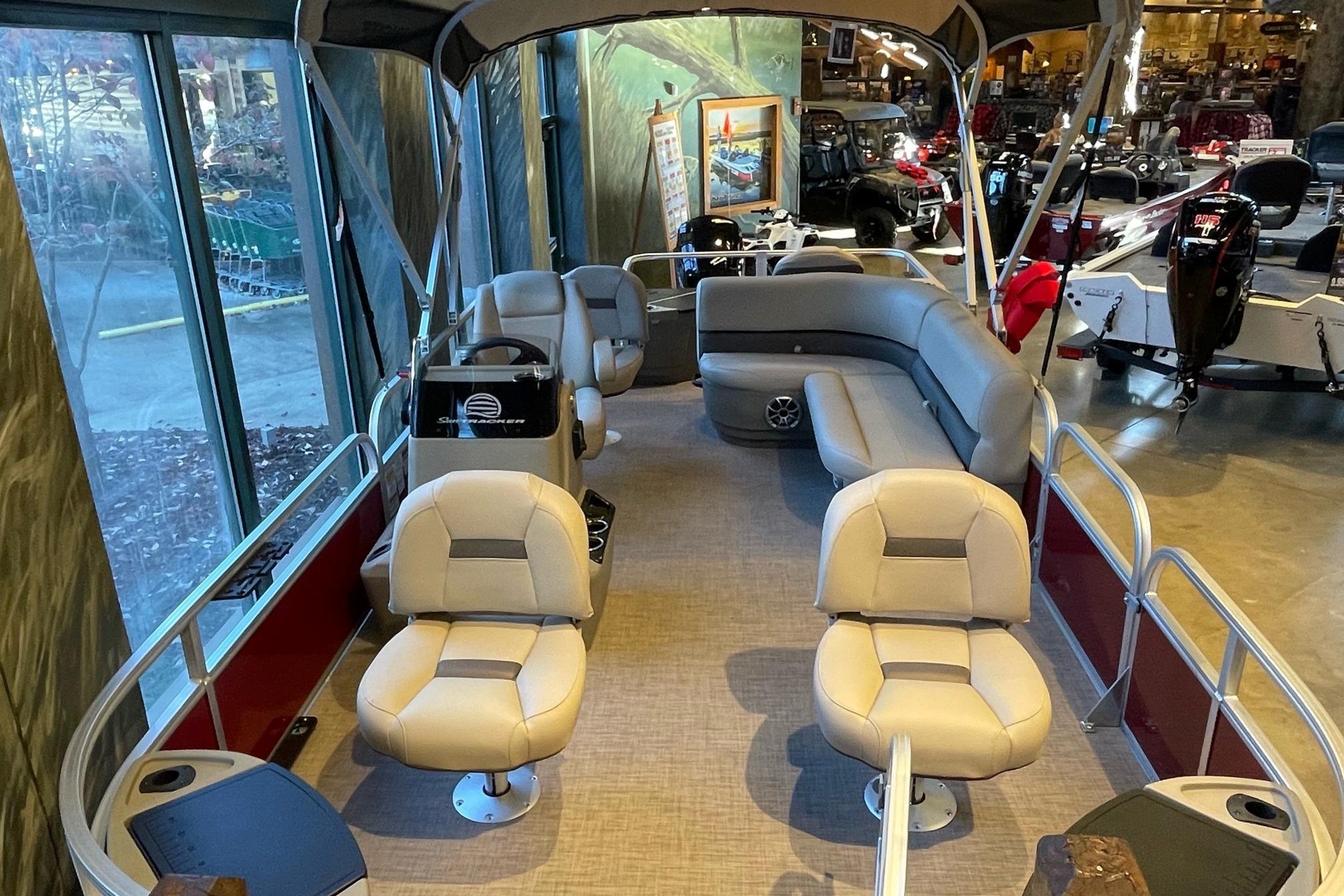 2026 Sun Tracker Bass Buggy 18 DLX pontoon boat interior with seating and canopy.