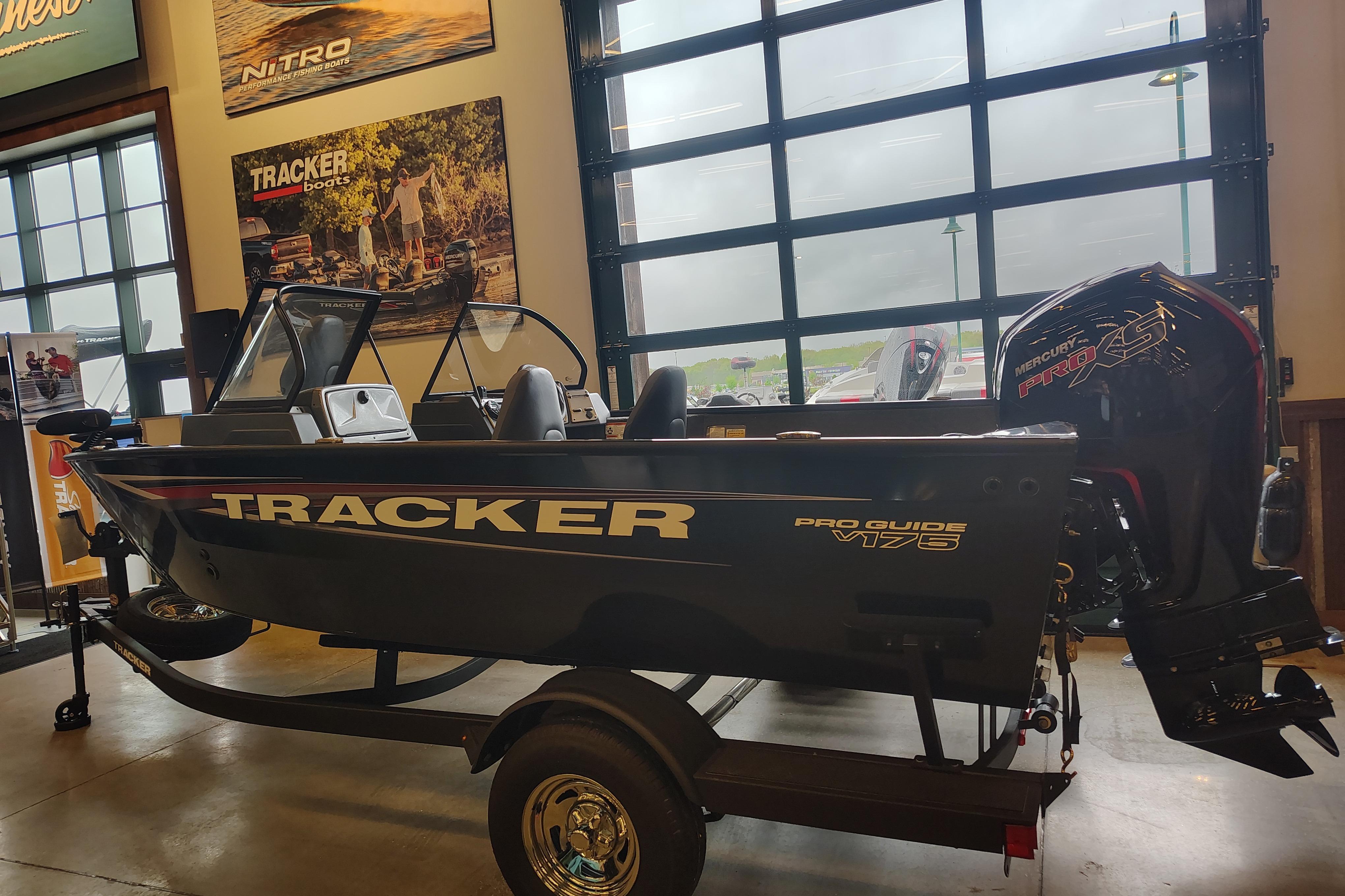 2026 Tracker Pro Guide V-175 WT boat displayed indoors with Mercury Pro XS engine.