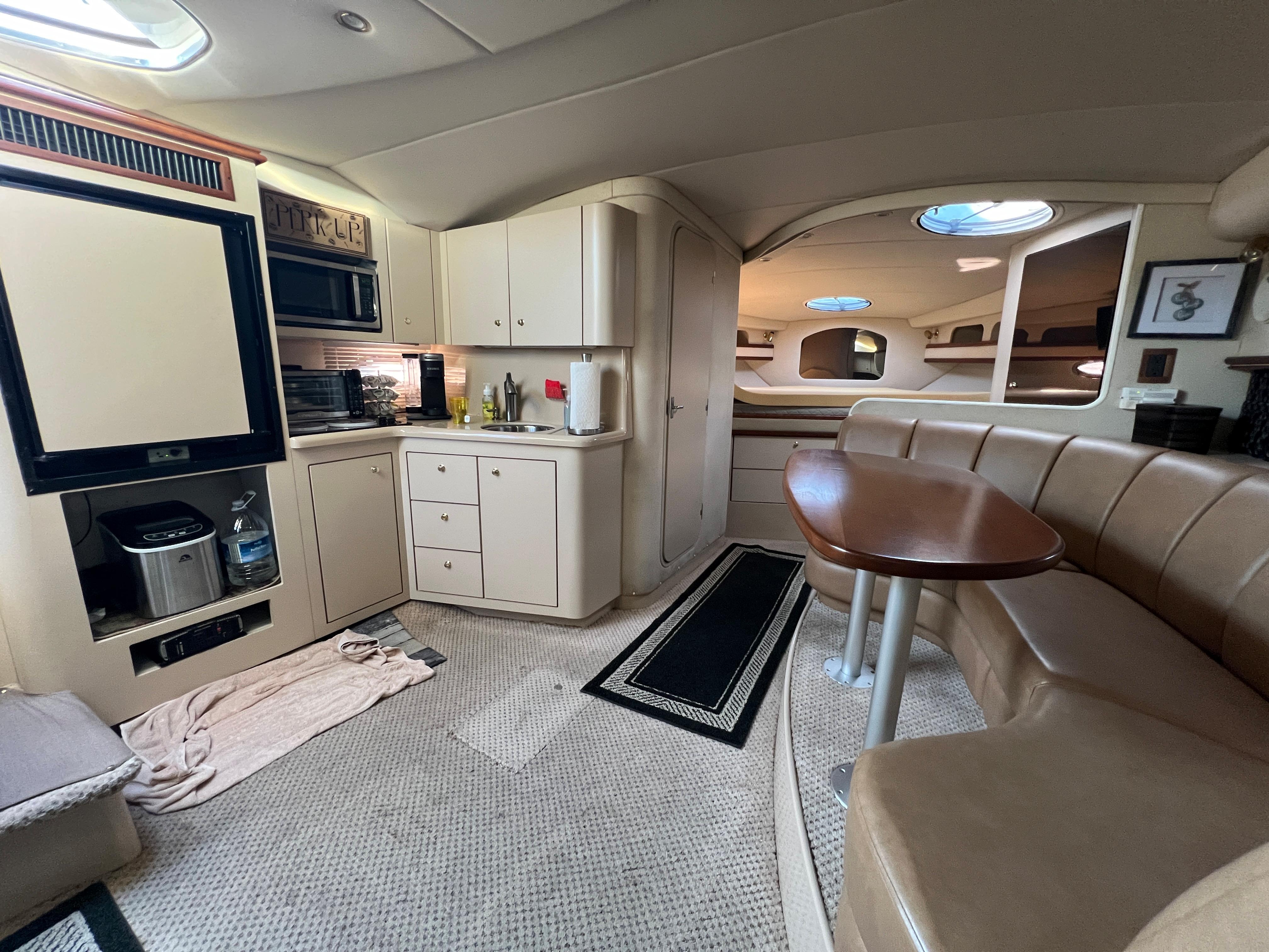 1999 Cruisers Yachts 3575 Esprit interior with kitchen and dining area.