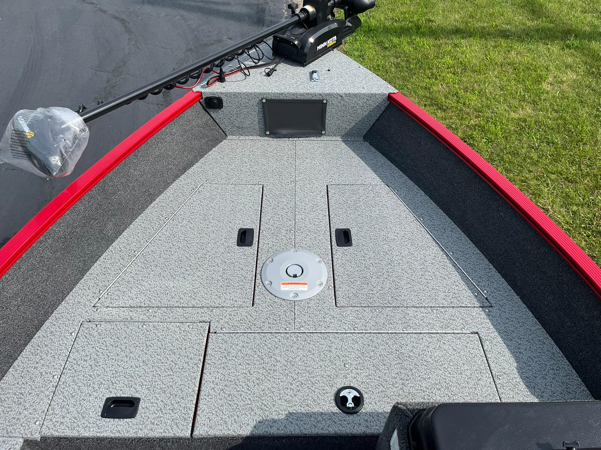 2026 Lund 1650 Angler SS boat deck with storage compartments and trolling motor.