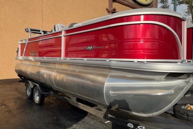 2026 Sun Tracker Party Barge 22 RF XP3 pontoon boat with red exterior on trailer.