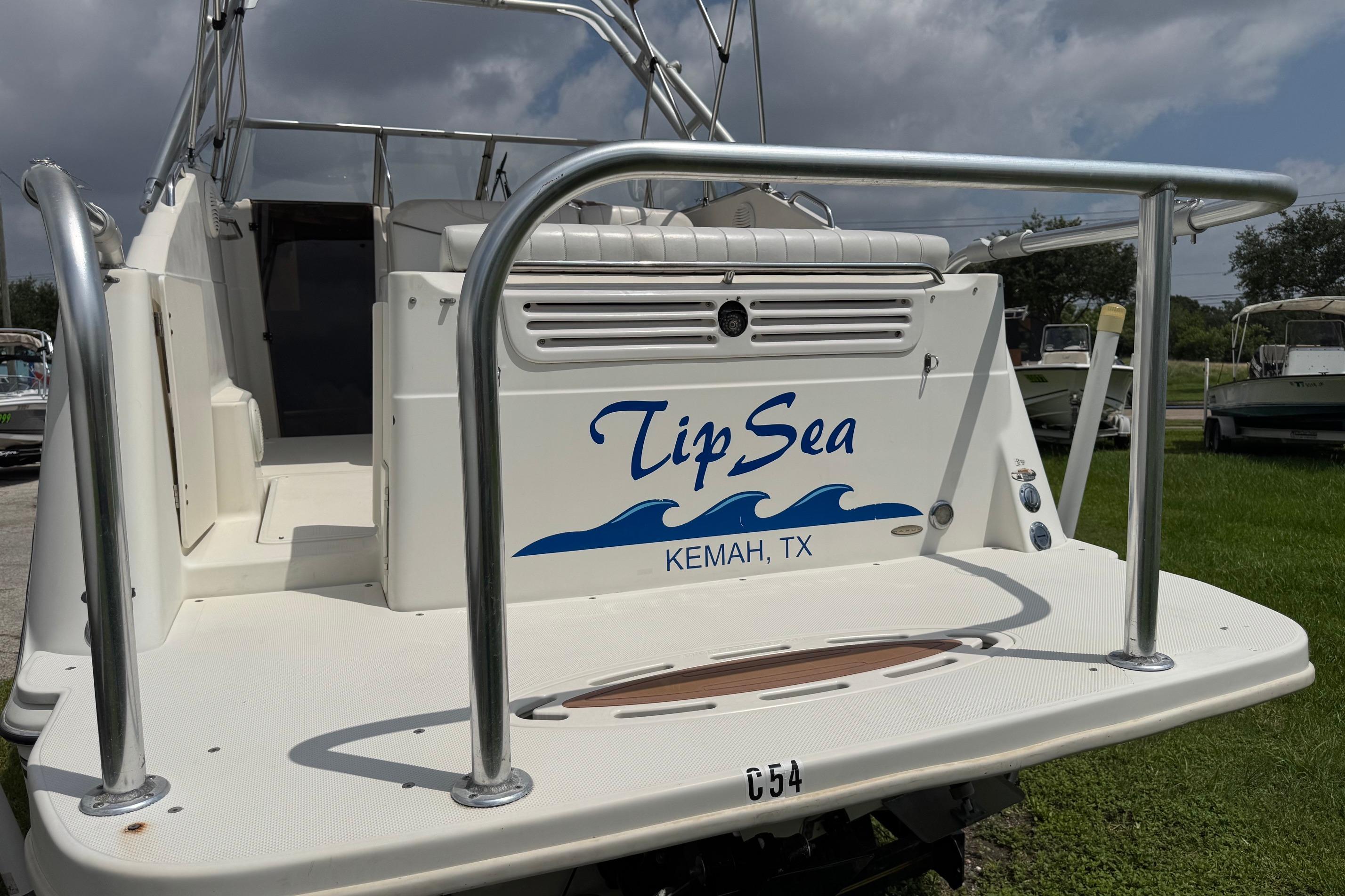 2000 Maxum 2400 SCR boat named "Tip Sea" in Kemah, TX, rear view.