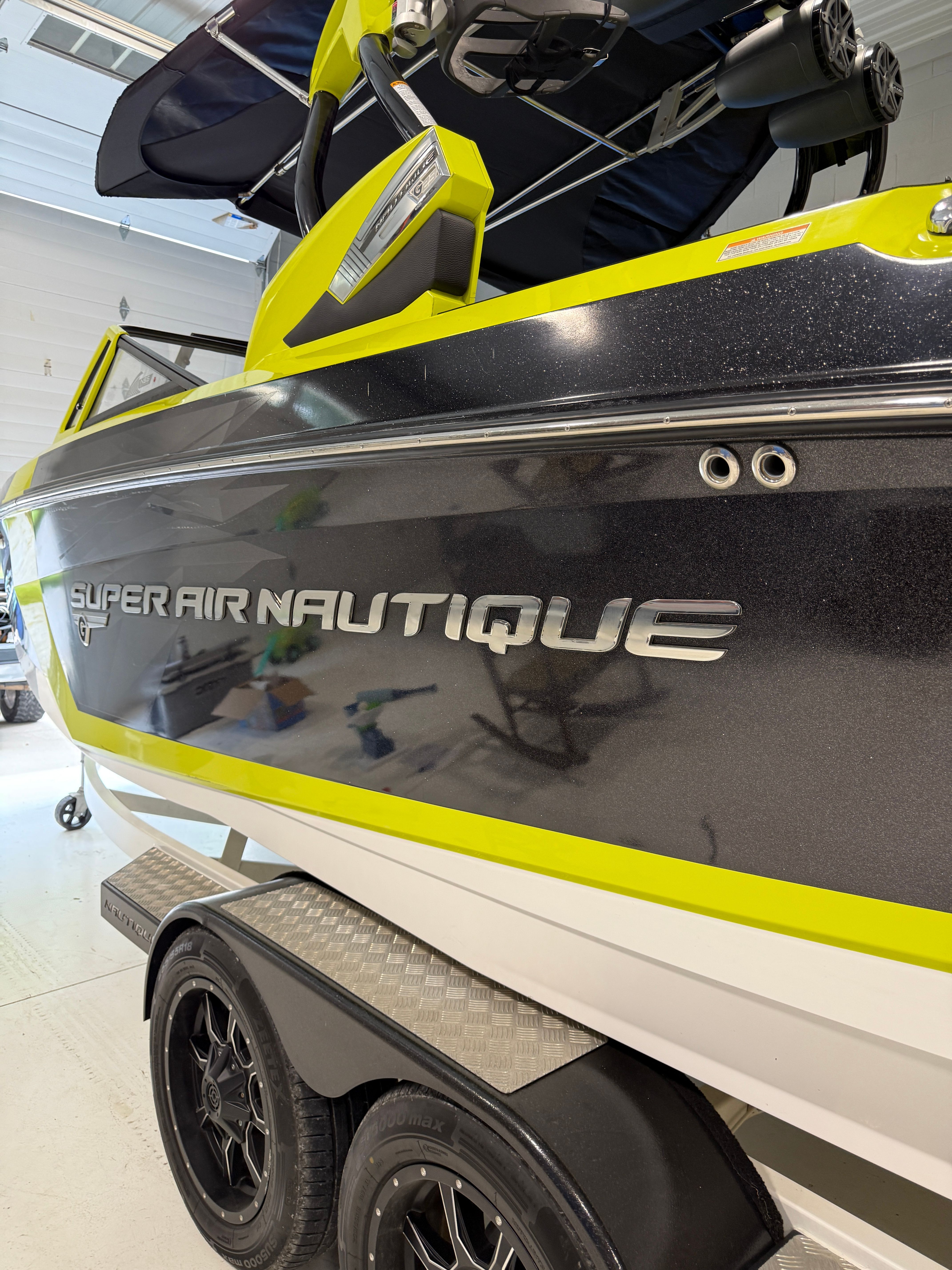 2016 Super Air Nautique G23 on a trailer in a showroom.