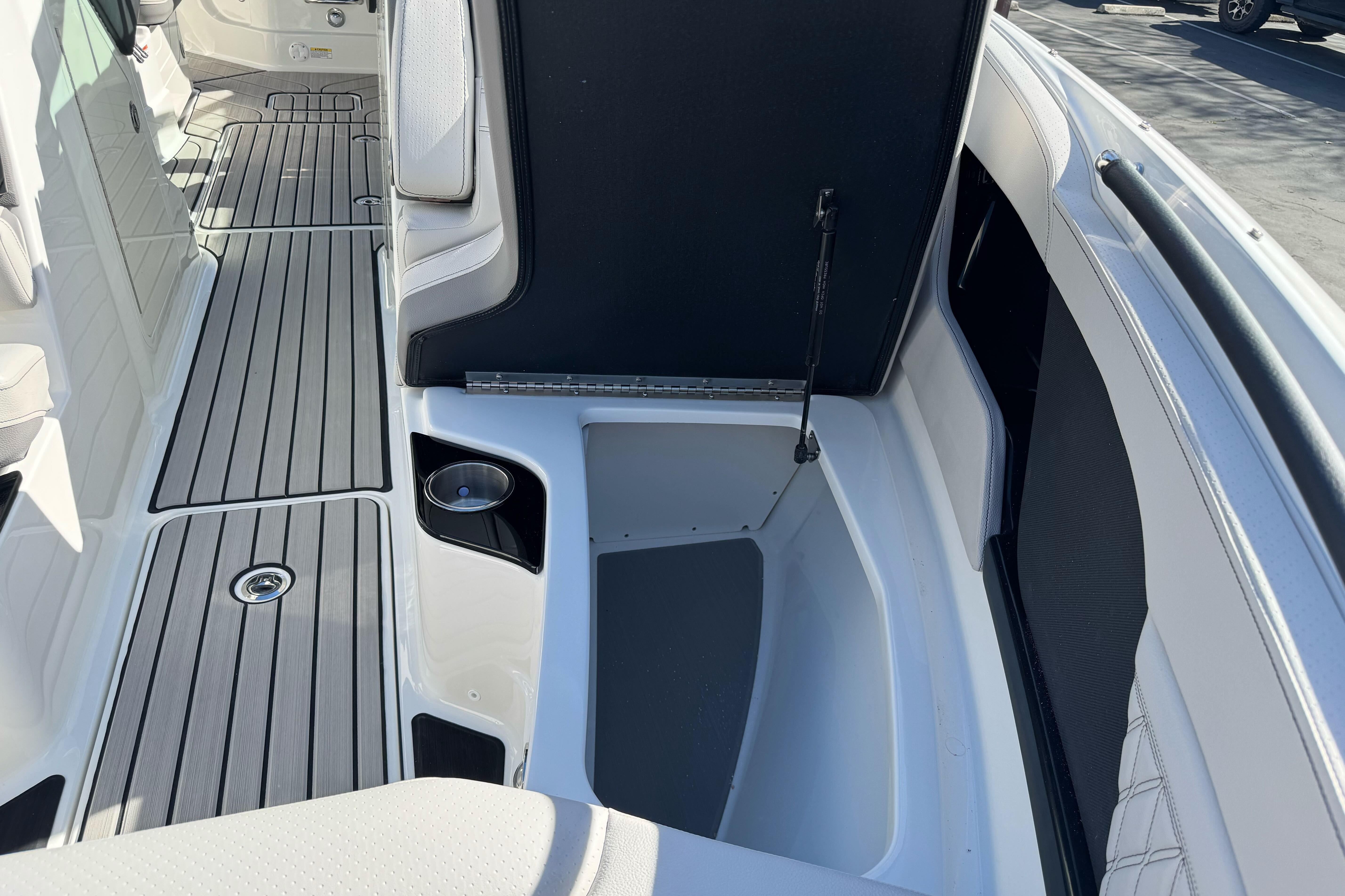 2026 Sea Ray SLX 260 boat interior with open storage compartment and sleek flooring.