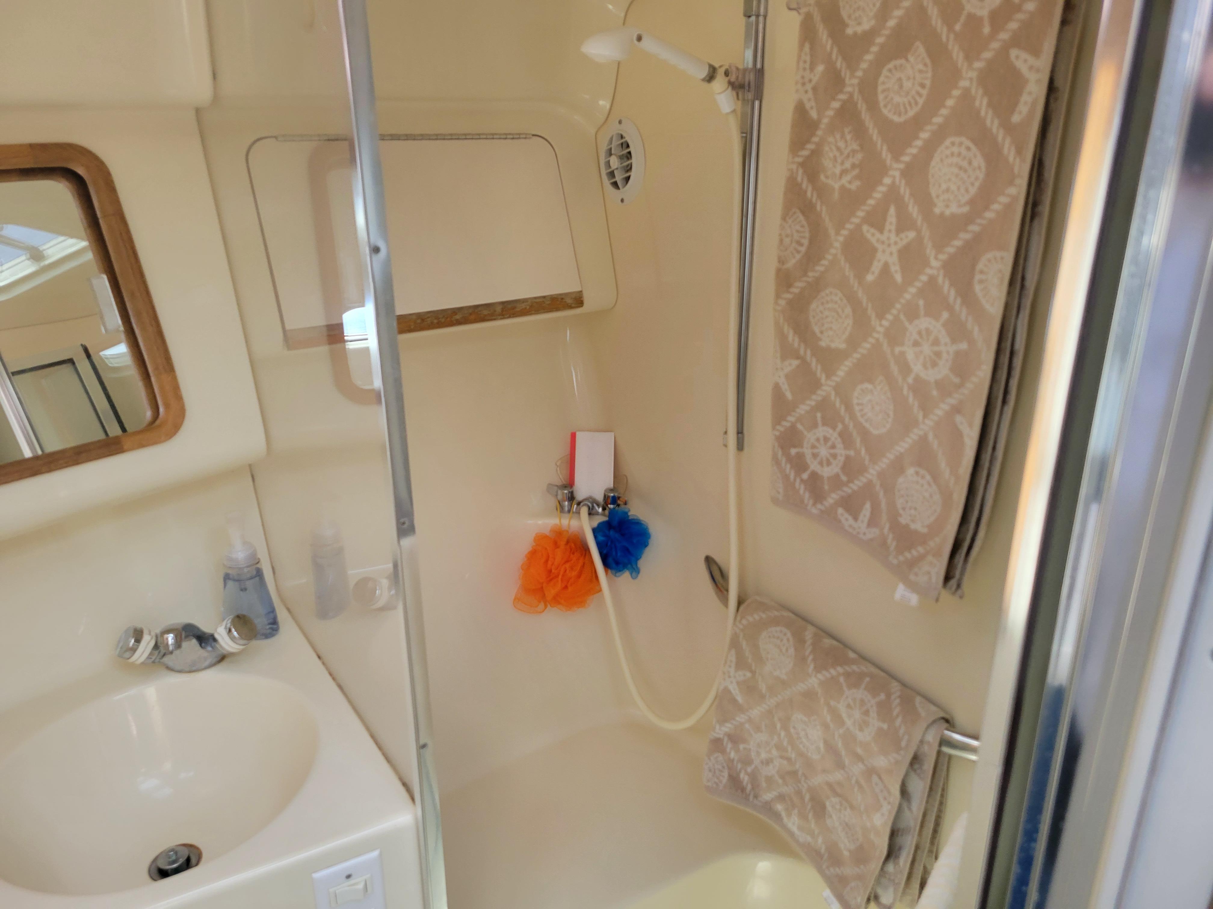 Bathroom interior of 1995 Sea Ray 370 Sundancer yacht with shower and sink.