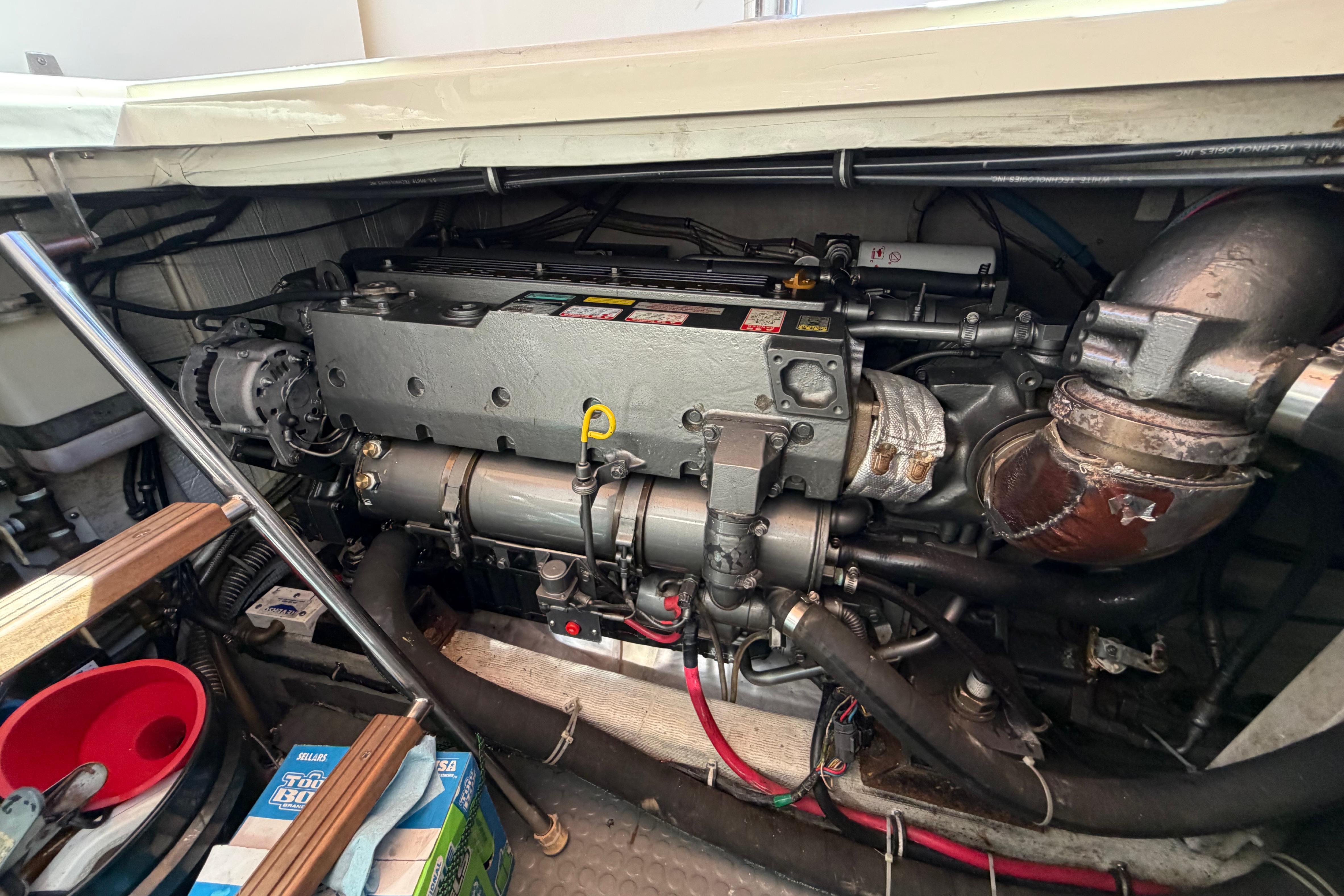 Engine compartment of a 2000 Sabreline 36 Express boat, showcasing detailed mechanical components.
