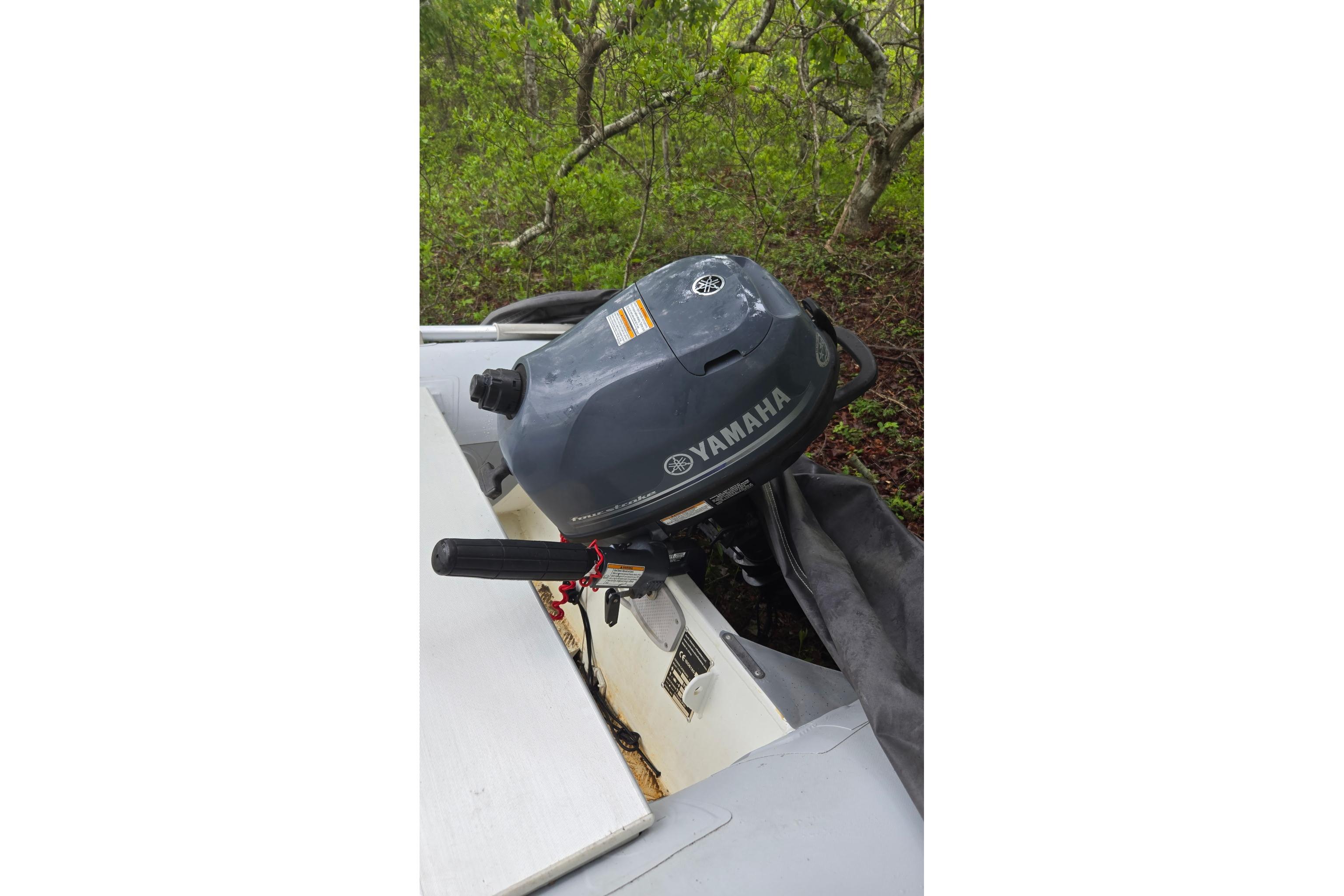 Yamaha outboard motor on a 1987 Marine Trader 36, surrounded by greenery.