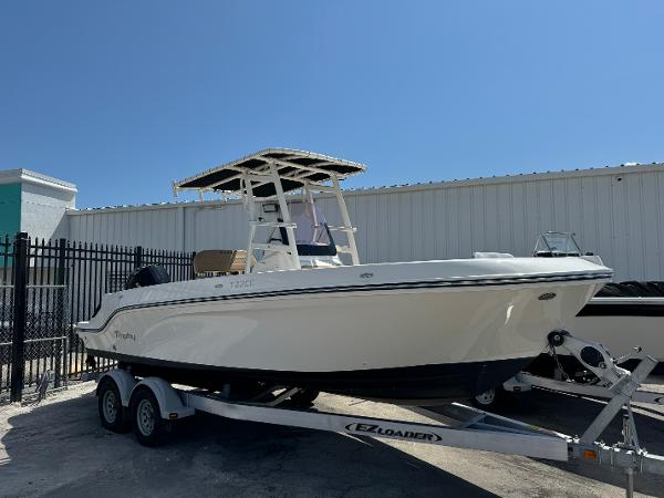 2021 Bayliner Trophy T22CC boat on EZ Loader trailer, parked outdoors.