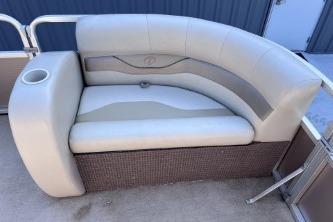 2012 Avalon Tahoe boat seat with beige upholstery and integrated cup holder.