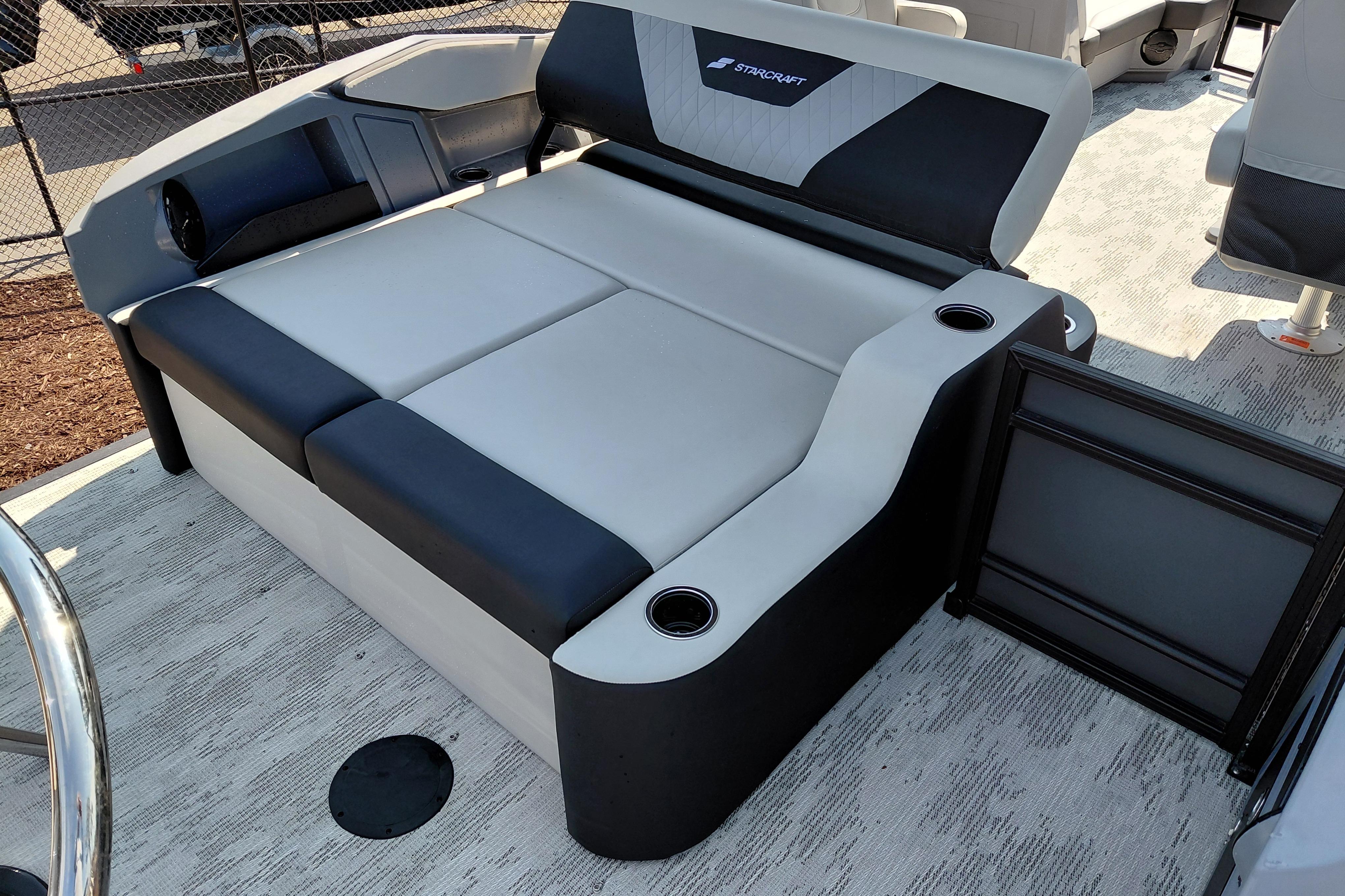 Luxurious seating on 2026 Starcraft VX 24 Q DH boat with cup holders and modern design.